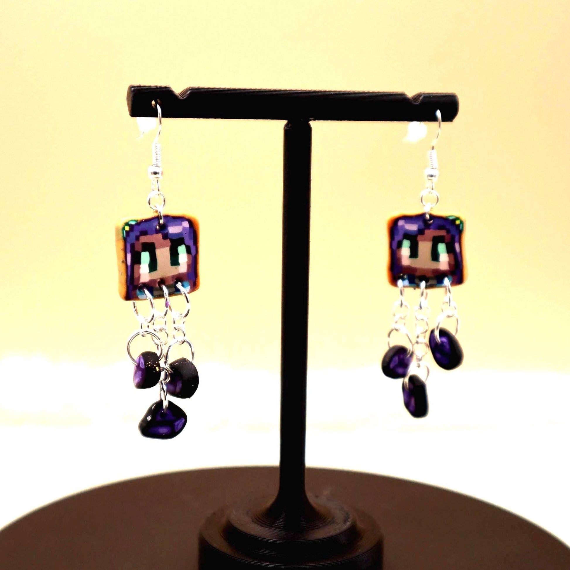 Handmade dangle earrings inspired by Abigail’s love of amethysts in Stardew Valley. Perfect gamer girl gift, cosplay jewelry, or crystal fan accessory.