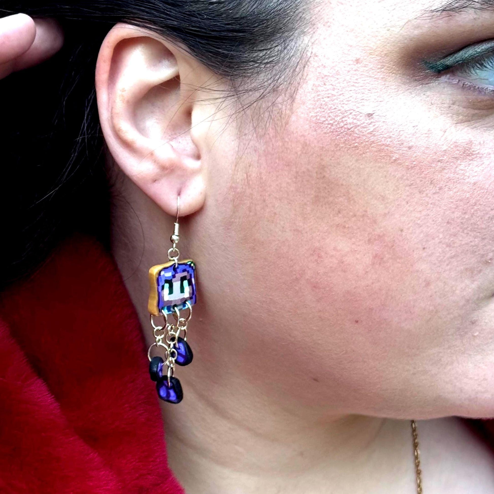 Handmade dangle earrings inspired by Abigail’s love of amethysts in Stardew Valley. Perfect gamer girl gift, cosplay jewelry, or crystal fan accessory.