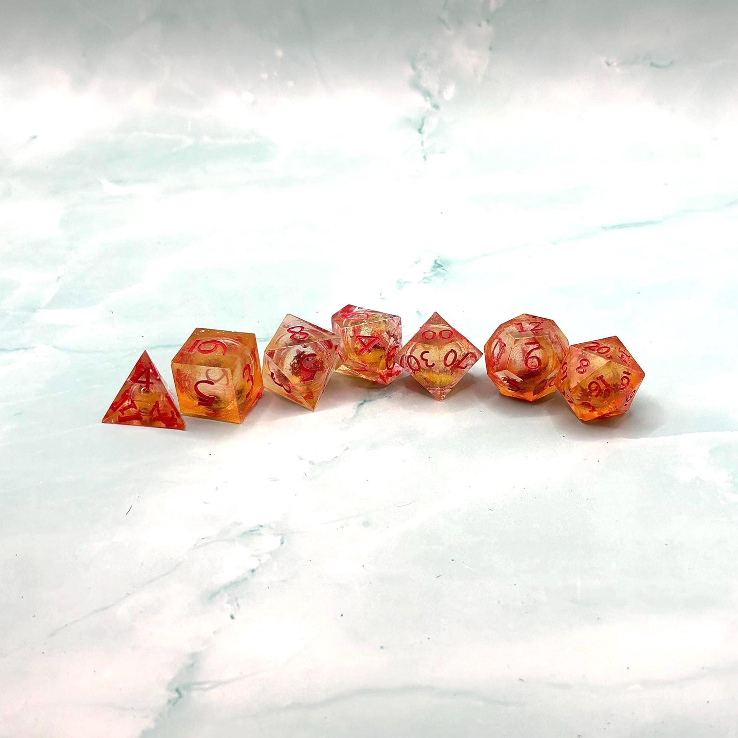 Orange Fall Foliage Liquid Core Dice Set – sharp edge polyhedral DnD dice featuring swirling autumn leaves and shimmering orange liquid core. Perfect for tabletop RPGs, Dungeons & Dragons, or dice collectors. Handmade resin dice with crisp numbers, glowing fall colors, and mesmerizing motion that captures the beauty of autumn. Ideal DnD gift or gaming accessory for players who love seasonal fantasy aesthetics.