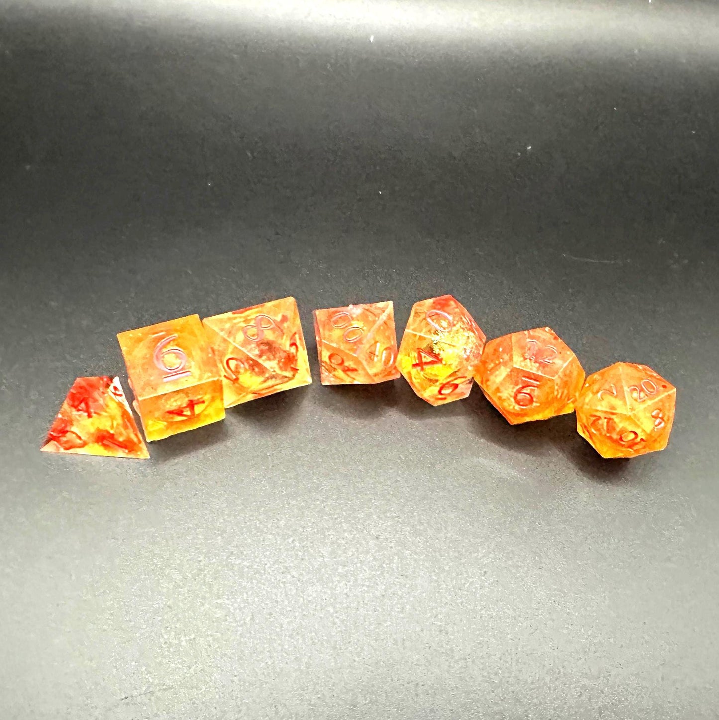 Orange Fall Foliage Liquid Core Dice Set – sharp edge polyhedral DnD dice featuring swirling autumn leaves and shimmering orange liquid core. Perfect for tabletop RPGs, Dungeons & Dragons, or dice collectors. Handmade resin dice with crisp numbers, glowing fall colors, and mesmerizing motion that captures the beauty of autumn. Ideal DnD gift or gaming accessory for players who love seasonal fantasy aesthetics.