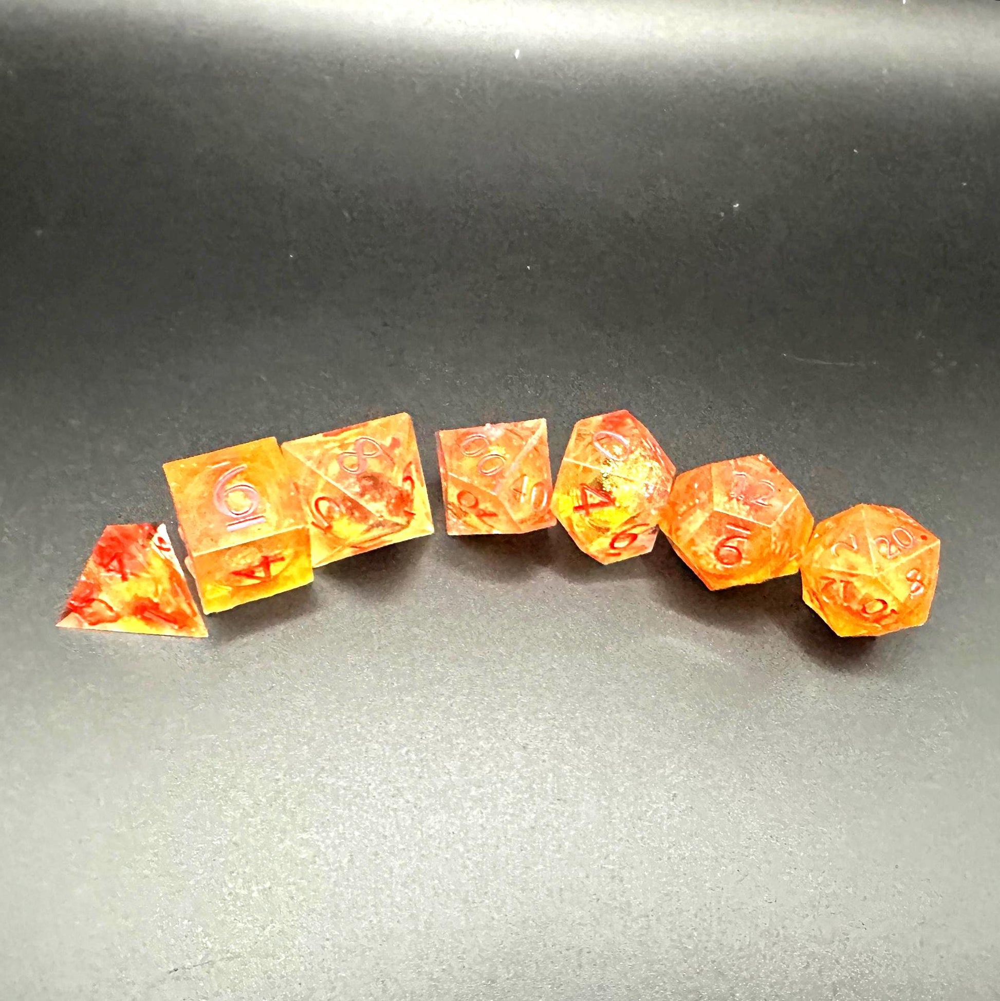 Orange Fall Foliage Liquid Core Dice Set – sharp edge polyhedral DnD dice featuring swirling autumn leaves and shimmering orange liquid core. Perfect for tabletop RPGs, Dungeons & Dragons, or dice collectors. Handmade resin dice with crisp numbers, glowing fall colors, and mesmerizing motion that captures the beauty of autumn. Ideal DnD gift or gaming accessory for players who love seasonal fantasy aesthetics.