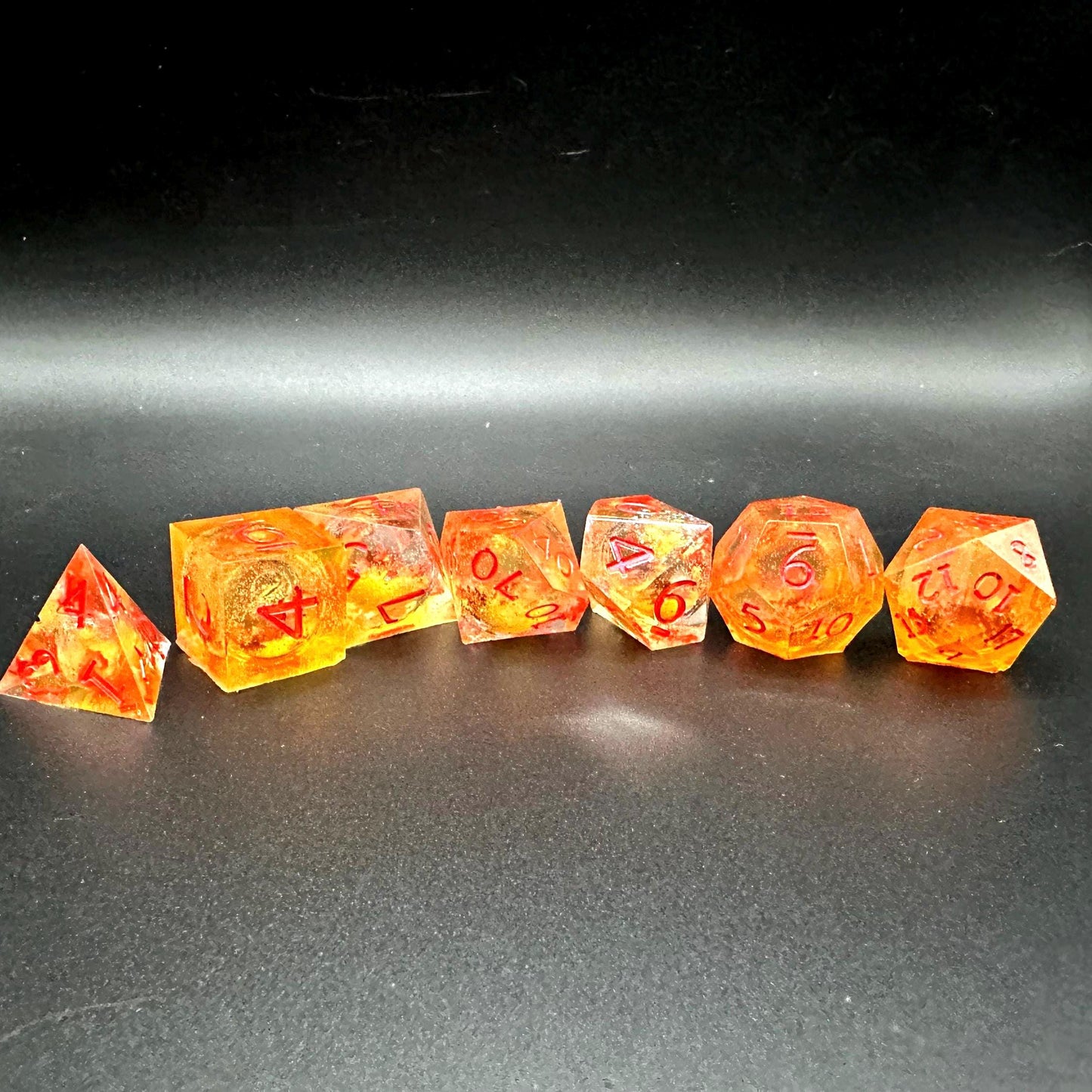 Orange Fall Foliage Liquid Core Dice Set – sharp edge polyhedral DnD dice featuring swirling autumn leaves and shimmering orange liquid core. Perfect for tabletop RPGs, Dungeons & Dragons, or dice collectors. Handmade resin dice with crisp numbers, glowing fall colors, and mesmerizing motion that captures the beauty of autumn. Ideal DnD gift or gaming accessory for players who love seasonal fantasy aesthetics.
