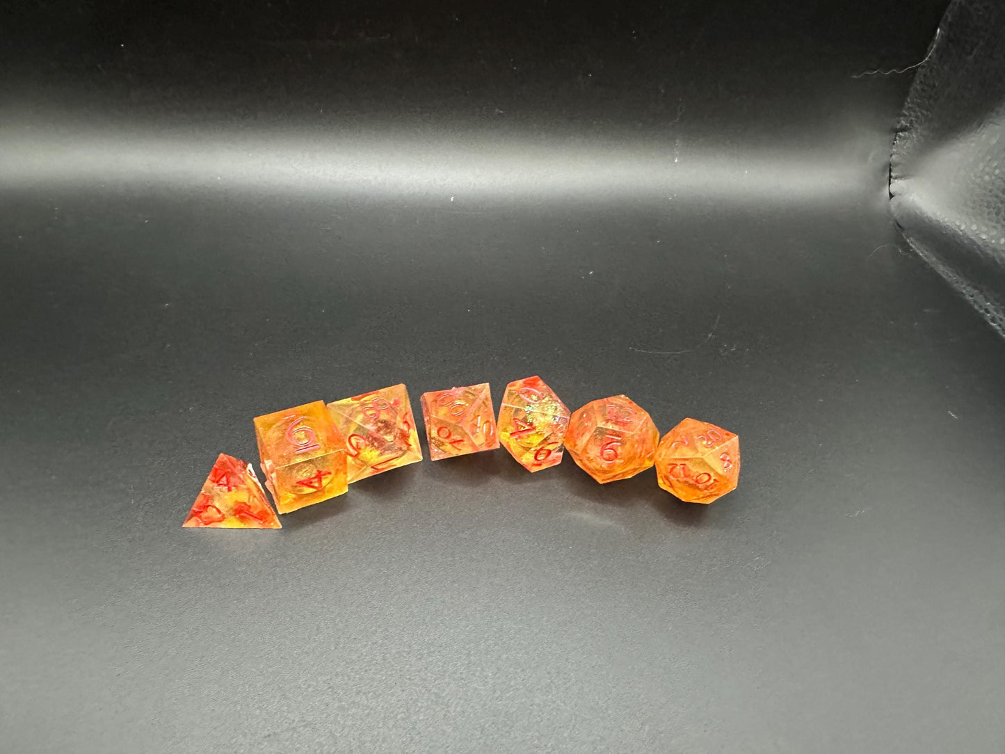 Orange Fall Foliage Liquid Core Dice Set – sharp edge polyhedral DnD dice featuring swirling autumn leaves and shimmering orange liquid core. Perfect for tabletop RPGs, Dungeons & Dragons, or dice collectors. Handmade resin dice with crisp numbers, glowing fall colors, and mesmerizing motion that captures the beauty of autumn. Ideal DnD gift or gaming accessory for players who love seasonal fantasy aesthetics.