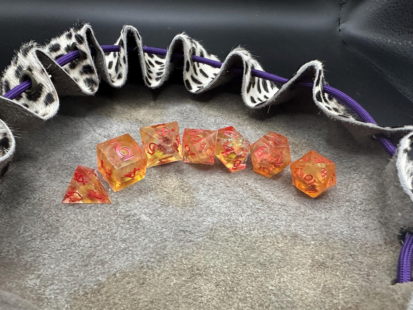 Orange Fall Foliage Liquid Core Dice Set – sharp edge polyhedral DnD dice featuring swirling autumn leaves and shimmering orange liquid core. Perfect for tabletop RPGs, Dungeons & Dragons, or dice collectors. Handmade resin dice with crisp numbers, glowing fall colors, and mesmerizing motion that captures the beauty of autumn. Ideal DnD gift or gaming accessory for players who love seasonal fantasy aesthetics.