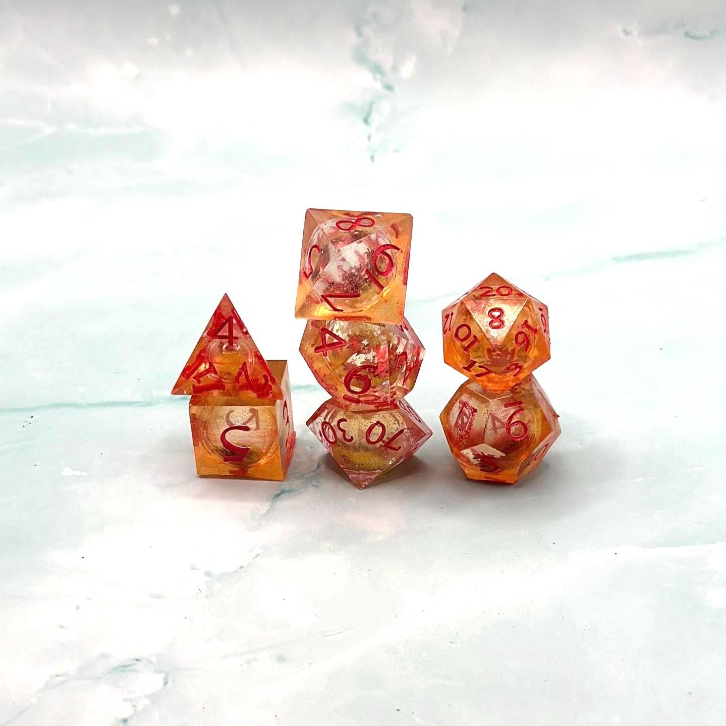 Orange Fall Foliage Liquid Core Dice Set – sharp edge polyhedral DnD dice featuring swirling autumn leaves and shimmering orange liquid core. Perfect for tabletop RPGs, Dungeons & Dragons, or dice collectors. Handmade resin dice with crisp numbers, glowing fall colors, and mesmerizing motion that captures the beauty of autumn. Ideal DnD gift or gaming accessory for players who love seasonal fantasy aesthetics.