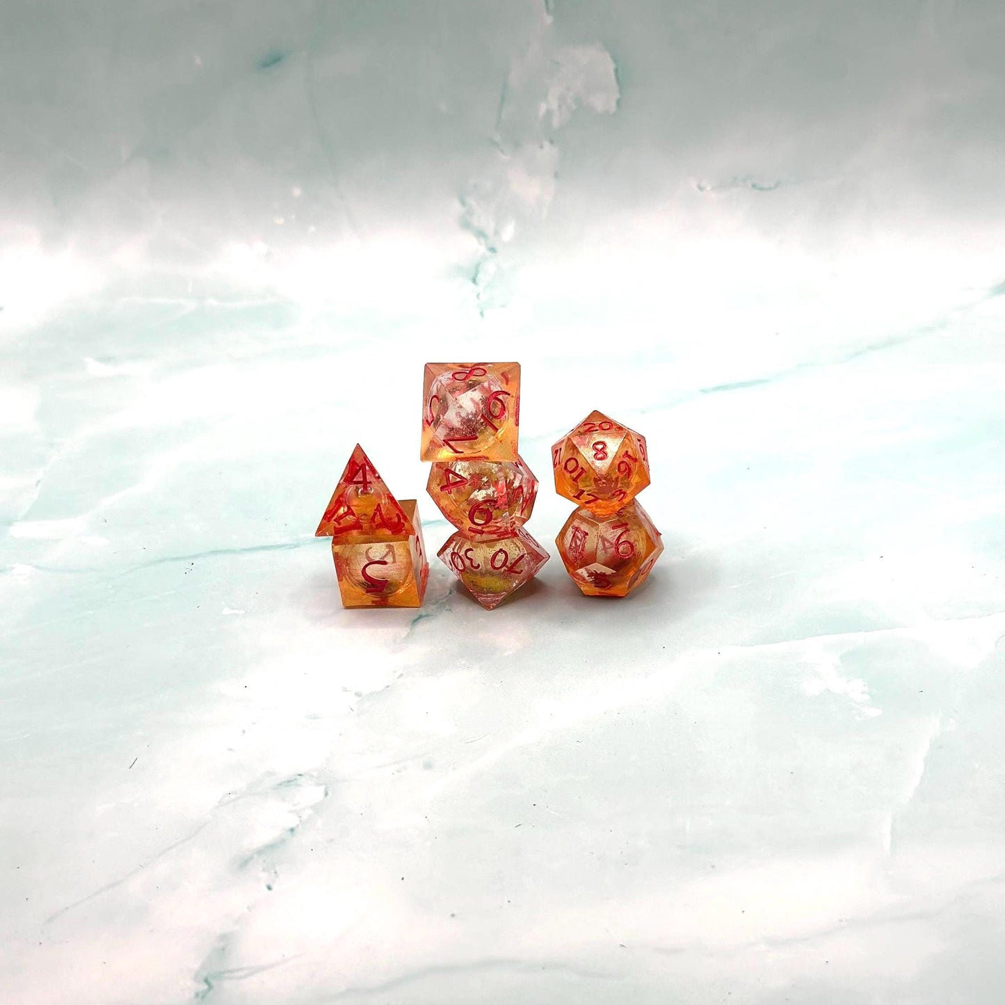 Orange Fall Foliage Liquid Core Dice Set – sharp edge polyhedral DnD dice featuring swirling autumn leaves and shimmering orange liquid core. Perfect for tabletop RPGs, Dungeons & Dragons, or dice collectors. Handmade resin dice with crisp numbers, glowing fall colors, and mesmerizing motion that captures the beauty of autumn. Ideal DnD gift or gaming accessory for players who love seasonal fantasy aesthetics.