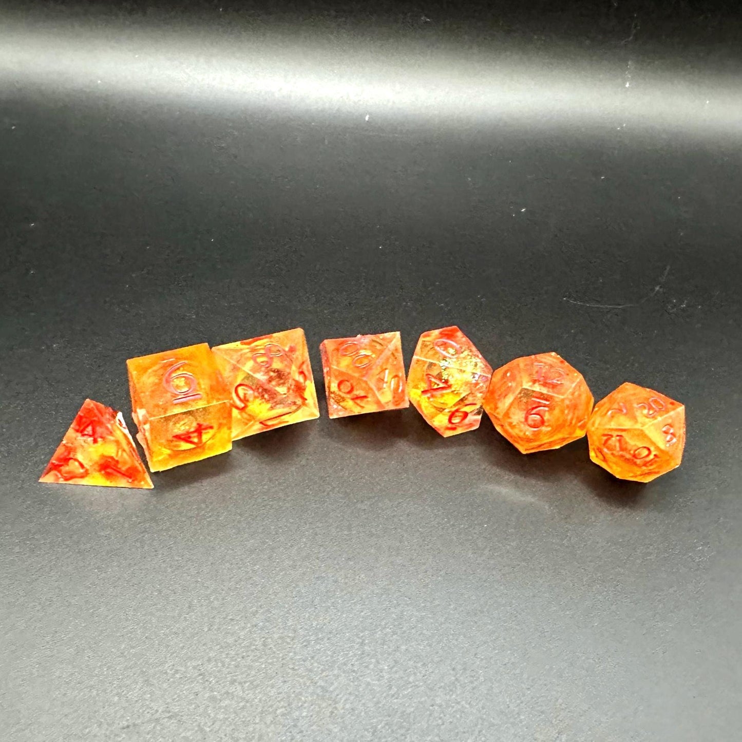 Orange Fall Foliage Liquid Core Dice Set – sharp edge polyhedral DnD dice featuring swirling autumn leaves and shimmering orange liquid core. Perfect for tabletop RPGs, Dungeons & Dragons, or dice collectors. Handmade resin dice with crisp numbers, glowing fall colors, and mesmerizing motion that captures the beauty of autumn. Ideal DnD gift or gaming accessory for players who love seasonal fantasy aesthetics.