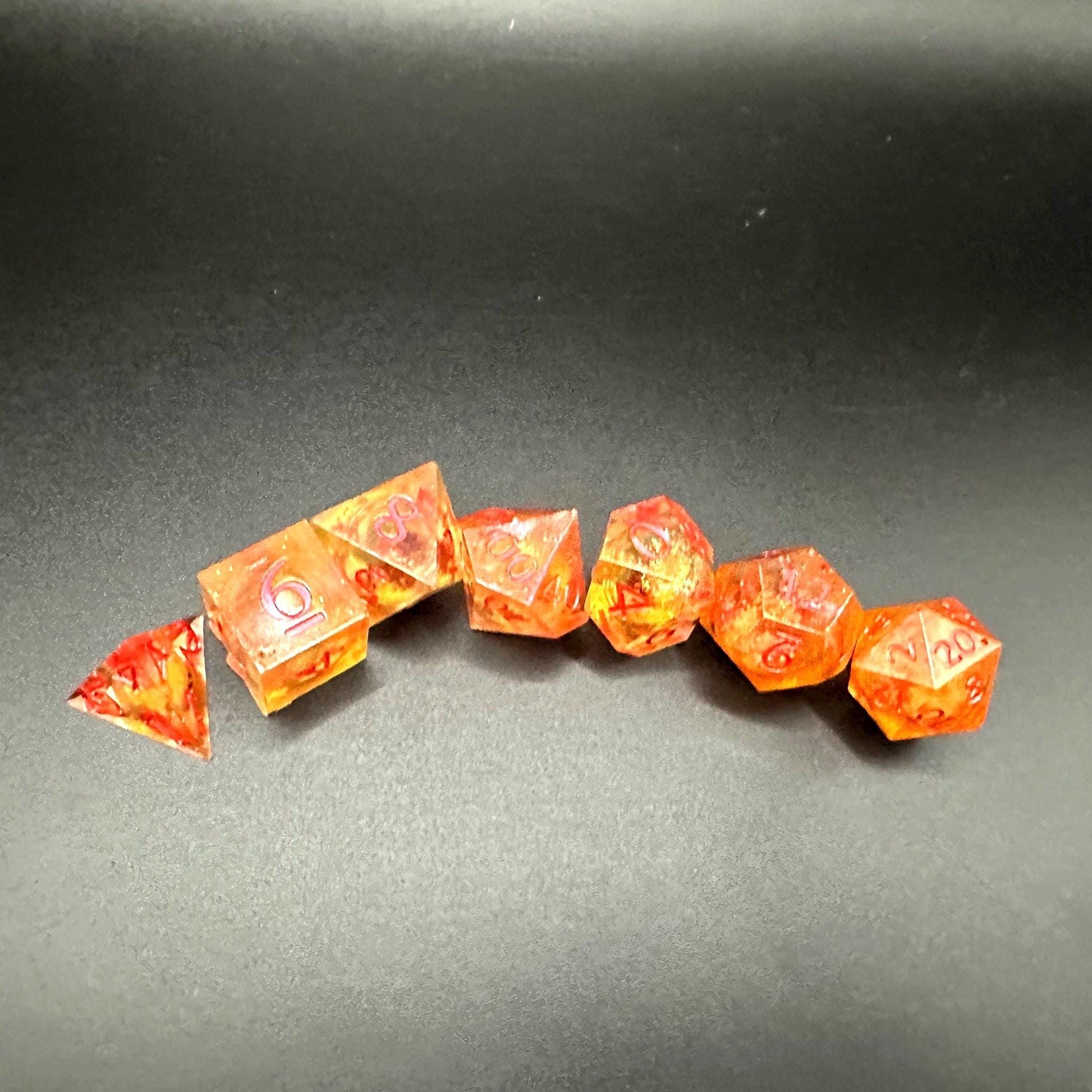 Orange Fall Foliage Liquid Core Dice Set – sharp edge polyhedral DnD dice featuring swirling autumn leaves and shimmering orange liquid core. Perfect for tabletop RPGs, Dungeons & Dragons, or dice collectors. Handmade resin dice with crisp numbers, glowing fall colors, and mesmerizing motion that captures the beauty of autumn. Ideal DnD gift or gaming accessory for players who love seasonal fantasy aesthetics.