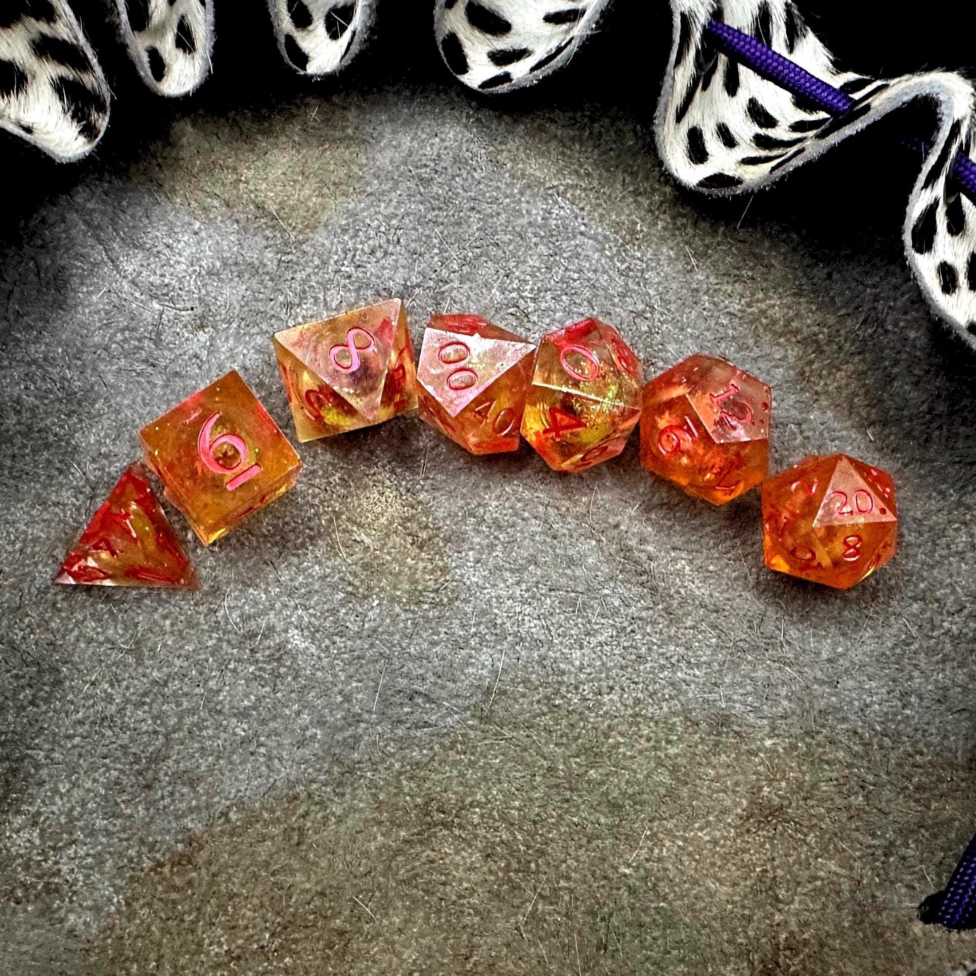 Orange Fall Foliage Liquid Core Dice Set – sharp edge polyhedral DnD dice featuring swirling autumn leaves and shimmering orange liquid core. Perfect for tabletop RPGs, Dungeons & Dragons, or dice collectors. Handmade resin dice with crisp numbers, glowing fall colors, and mesmerizing motion that captures the beauty of autumn. Ideal DnD gift or gaming accessory for players who love seasonal fantasy aesthetics.
