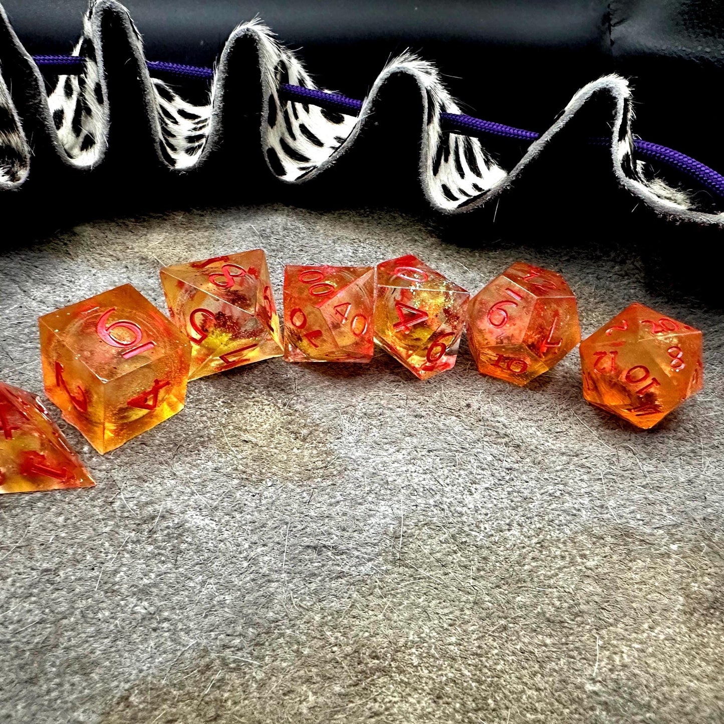 Orange Fall Foliage Liquid Core Dice Set – sharp edge polyhedral DnD dice featuring swirling autumn leaves and shimmering orange liquid core. Perfect for tabletop RPGs, Dungeons & Dragons, or dice collectors. Handmade resin dice with crisp numbers, glowing fall colors, and mesmerizing motion that captures the beauty of autumn. Ideal DnD gift or gaming accessory for players who love seasonal fantasy aesthetics.