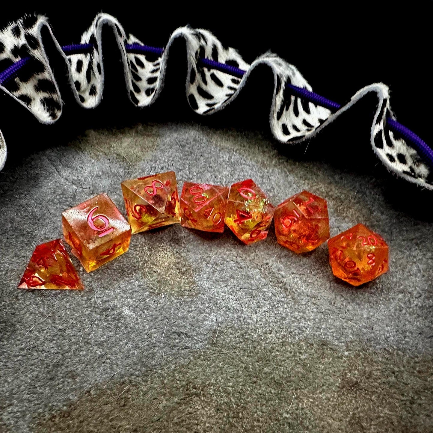 Orange Fall Foliage Liquid Core Dice Set – sharp edge polyhedral DnD dice featuring swirling autumn leaves and shimmering orange liquid core. Perfect for tabletop RPGs, Dungeons & Dragons, or dice collectors. Handmade resin dice with crisp numbers, glowing fall colors, and mesmerizing motion that captures the beauty of autumn. Ideal DnD gift or gaming accessory for players who love seasonal fantasy aesthetics.