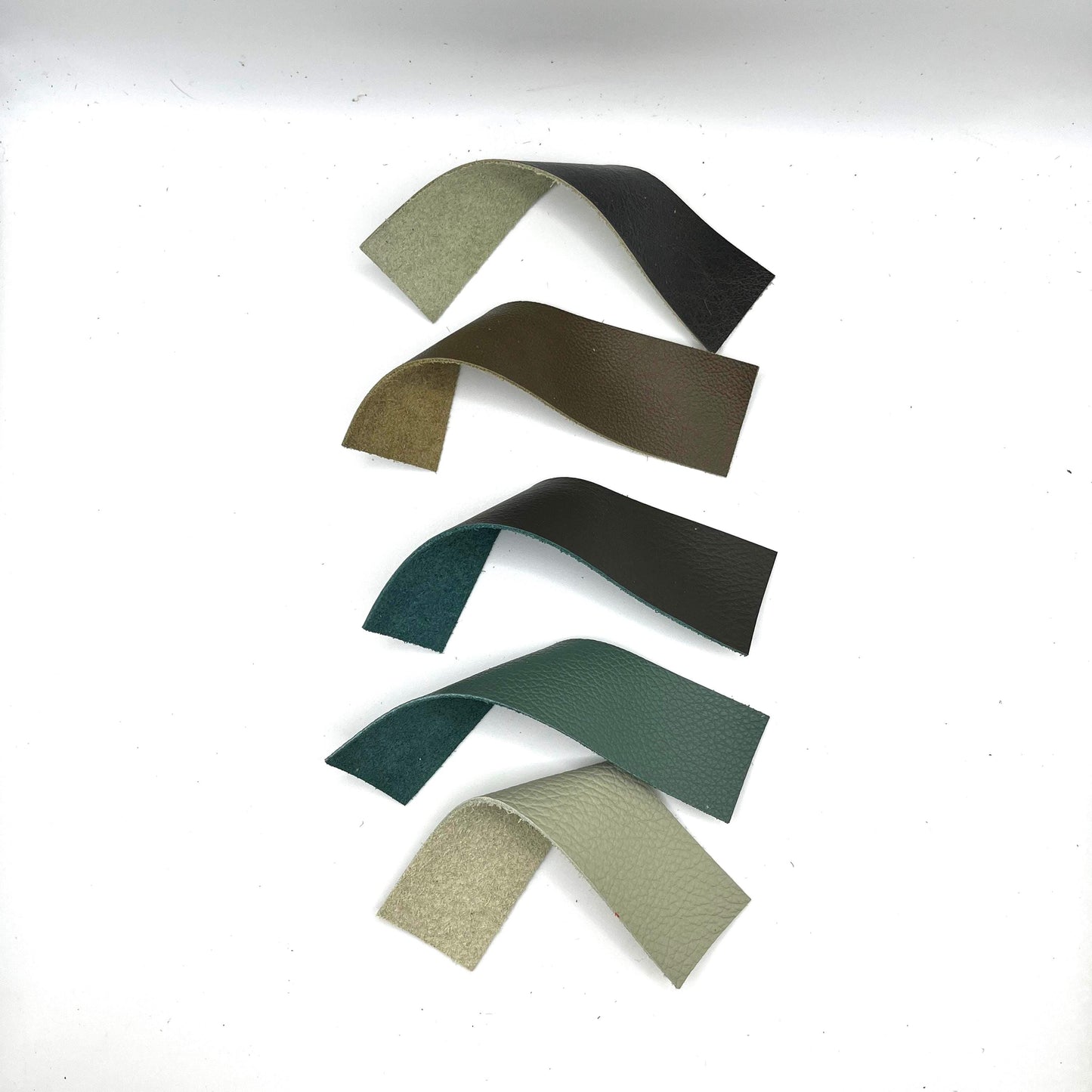 Handmade upcycled Italian green leather bookmark cut from upholstery-grade leather scraps, slim durable page marker with natural grain, sustainable gift for readers and book lovers