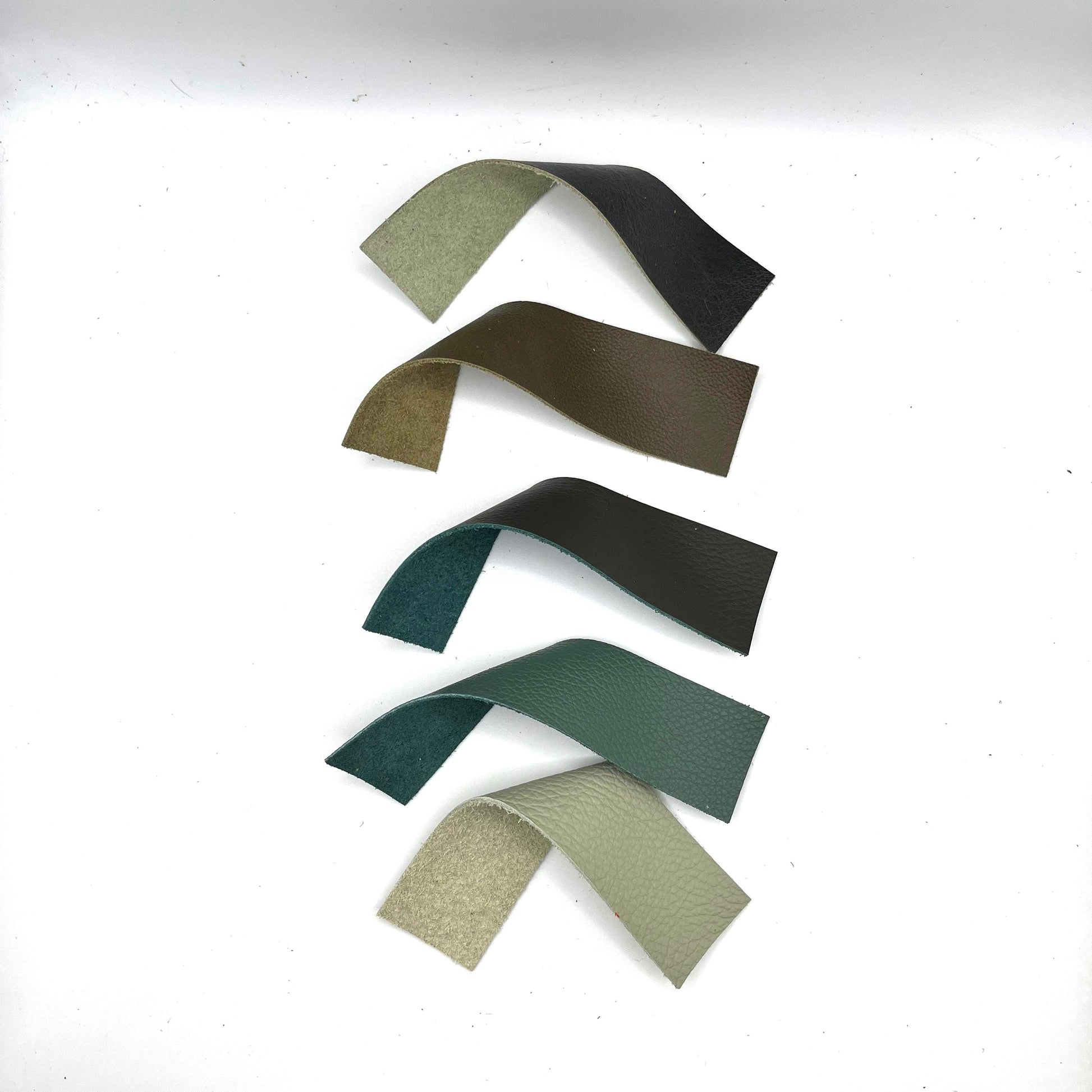 Handmade upcycled Italian green leather bookmark cut from upholstery-grade leather scraps, slim durable page marker with natural grain, sustainable gift for readers and book lovers