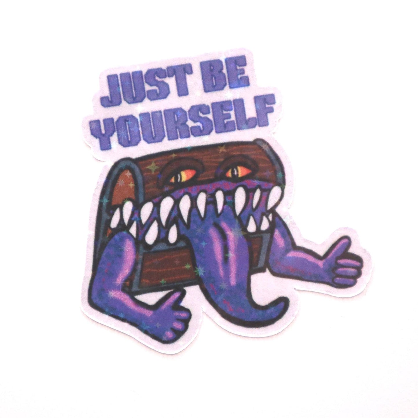 Holographic DnD mimic sticker with a grinning treasure chest and the phrase Just Be Yourself, perfect for laptops, water bottles, and tabletop RPG fans.