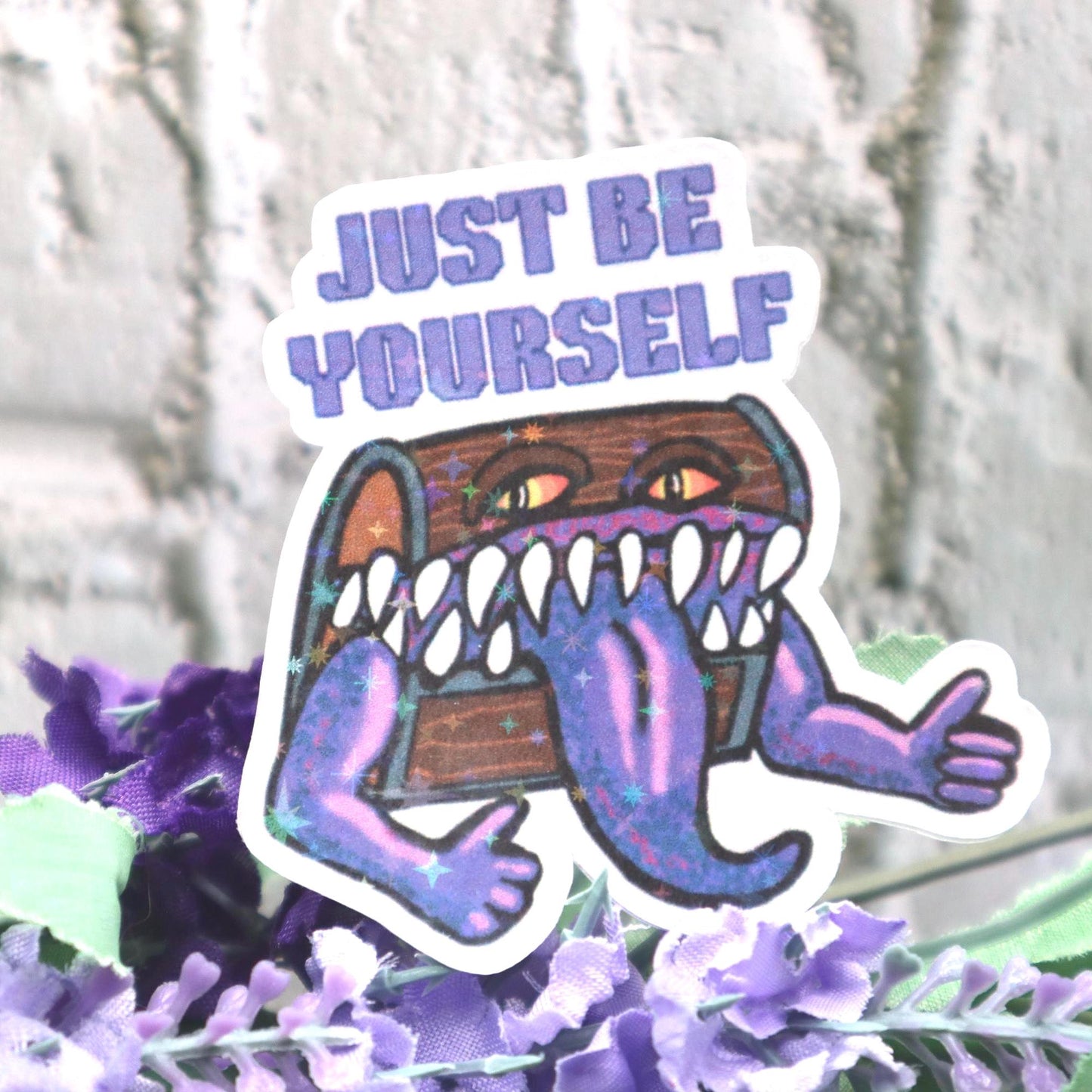 Holographic DnD mimic sticker with a grinning treasure chest and the phrase Just Be Yourself, perfect for laptops, water bottles, and tabletop RPG fans.
