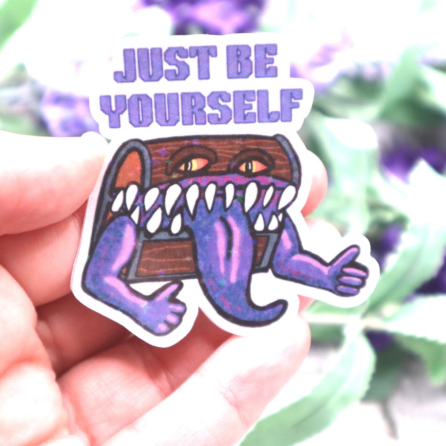 Holographic DnD mimic sticker with a grinning treasure chest and the phrase Just Be Yourself, perfect for laptops, water bottles, and tabletop RPG fans.