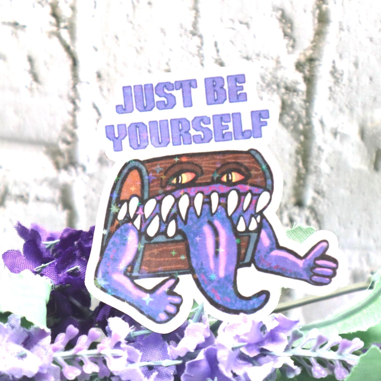 Holographic DnD mimic sticker with a grinning treasure chest and the phrase Just Be Yourself, perfect for laptops, water bottles, and tabletop RPG fans.