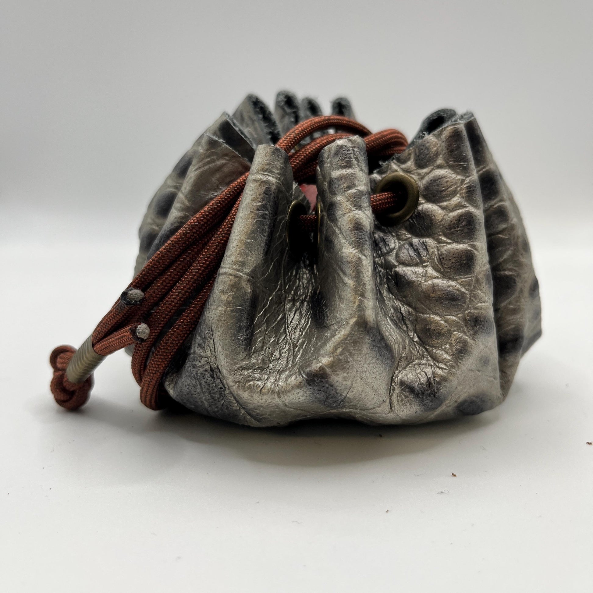Handcrafted leather dice bag with drawstring, ideal for storing RPG dice sets. Perfect for DnD, tabletop games, or as a fantasy gift for gamers.