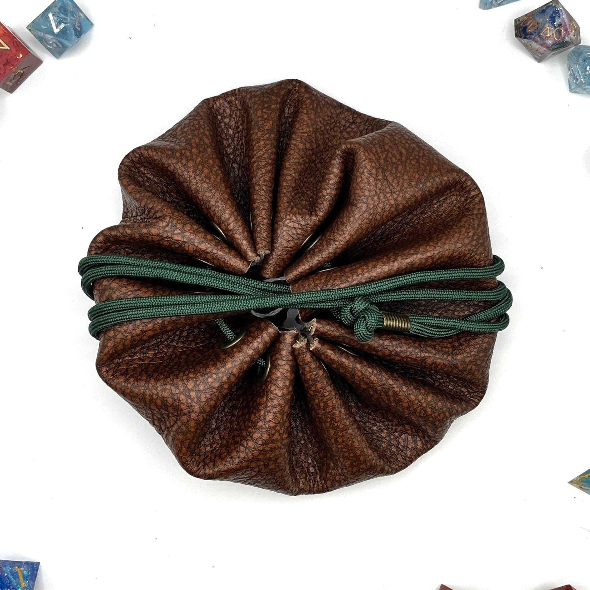 Handcrafted leather dice bag with drawstring, ideal for storing RPG dice sets. Perfect for DnD, tabletop games, or as a fantasy gift for gamers.