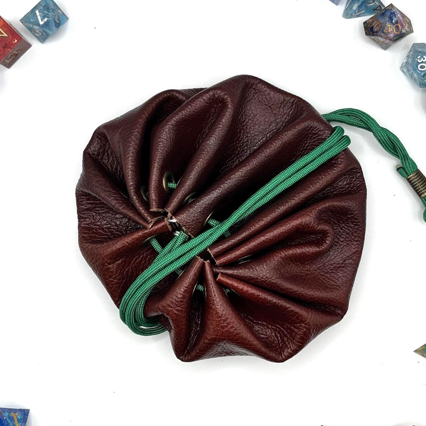 Handcrafted leather dice bag with drawstring, ideal for storing RPG dice sets. Perfect for DnD, tabletop games, or as a fantasy gift for gamers.