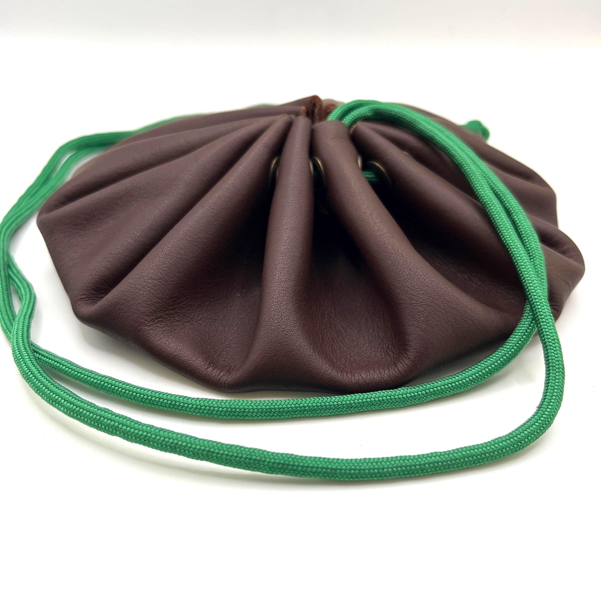 Handcrafted leather dice bag with drawstring, ideal for storing RPG dice sets. Perfect for DnD, tabletop games, or as a fantasy gift for gamers.