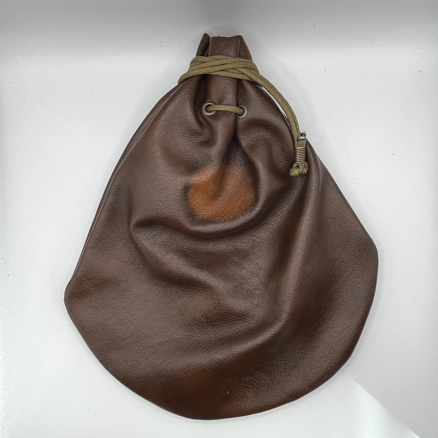 Handcrafted leather dice bag with drawstring, ideal for storing RPG dice sets. Perfect for DnD, tabletop games, or as a fantasy gift for gamers.