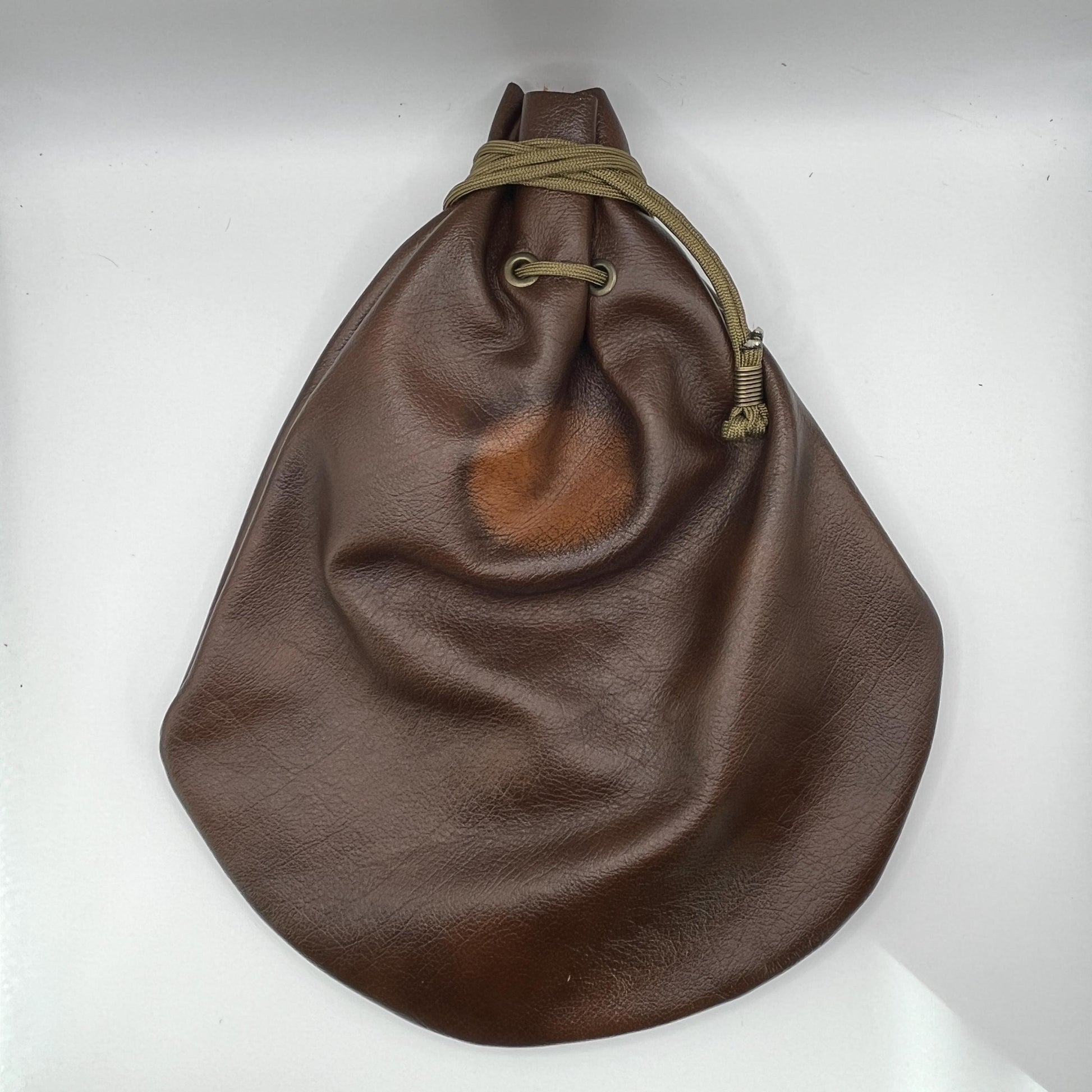 Handcrafted leather dice bag with drawstring, ideal for storing RPG dice sets. Perfect for DnD, tabletop games, or as a fantasy gift for gamers.
