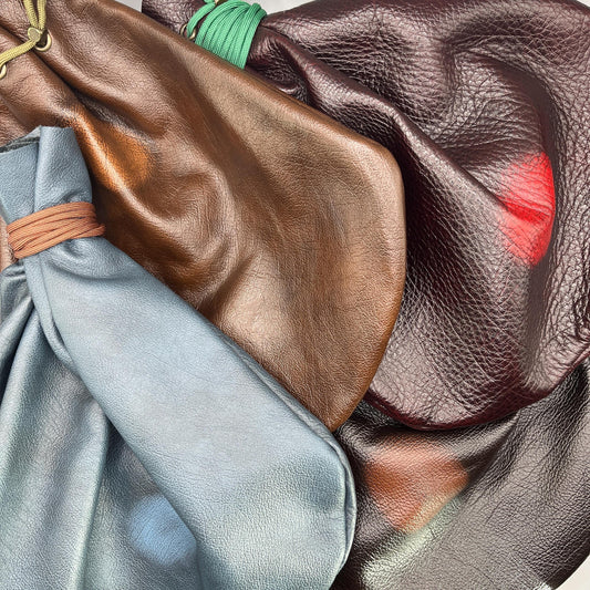 Handcrafted leather dice bag with drawstring, ideal for storing RPG dice sets. Perfect for DnD, tabletop games, or as a fantasy gift for gamers.