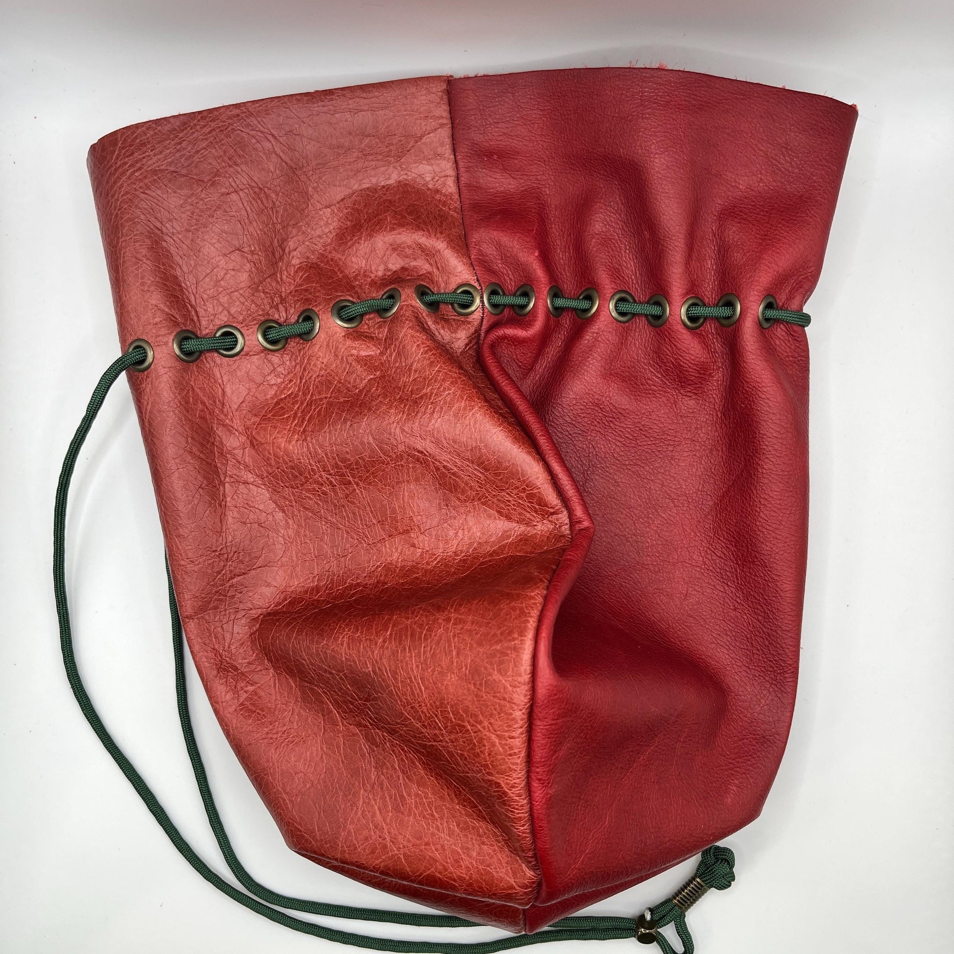 Handcrafted leather dice bag with drawstring, ideal for storing RPG dice sets. Perfect for DnD, tabletop games, or as a fantasy gift for gamers.