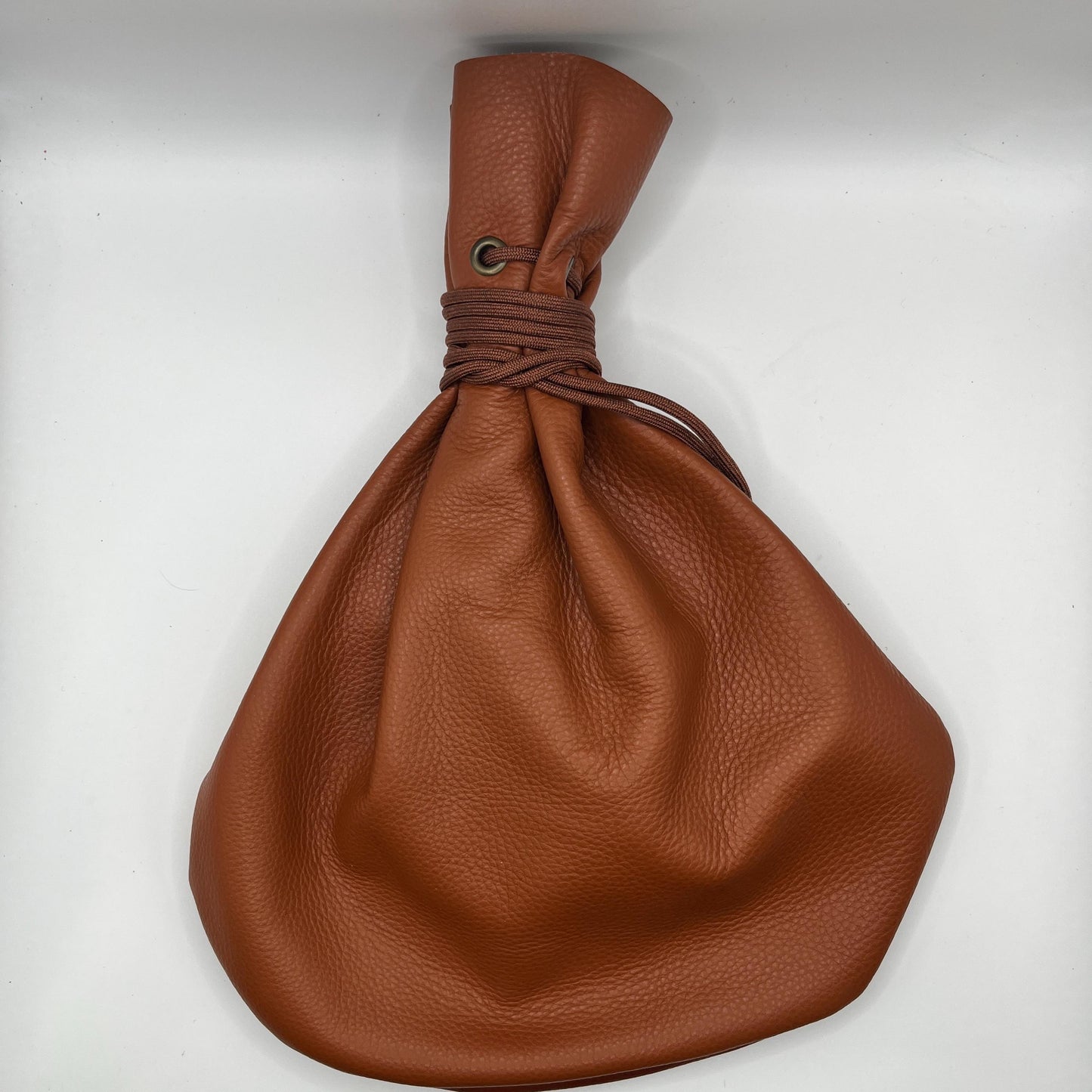 Handcrafted leather dice bag with drawstring, ideal for storing RPG dice sets. Perfect for DnD, tabletop games, or as a fantasy gift for gamers.
