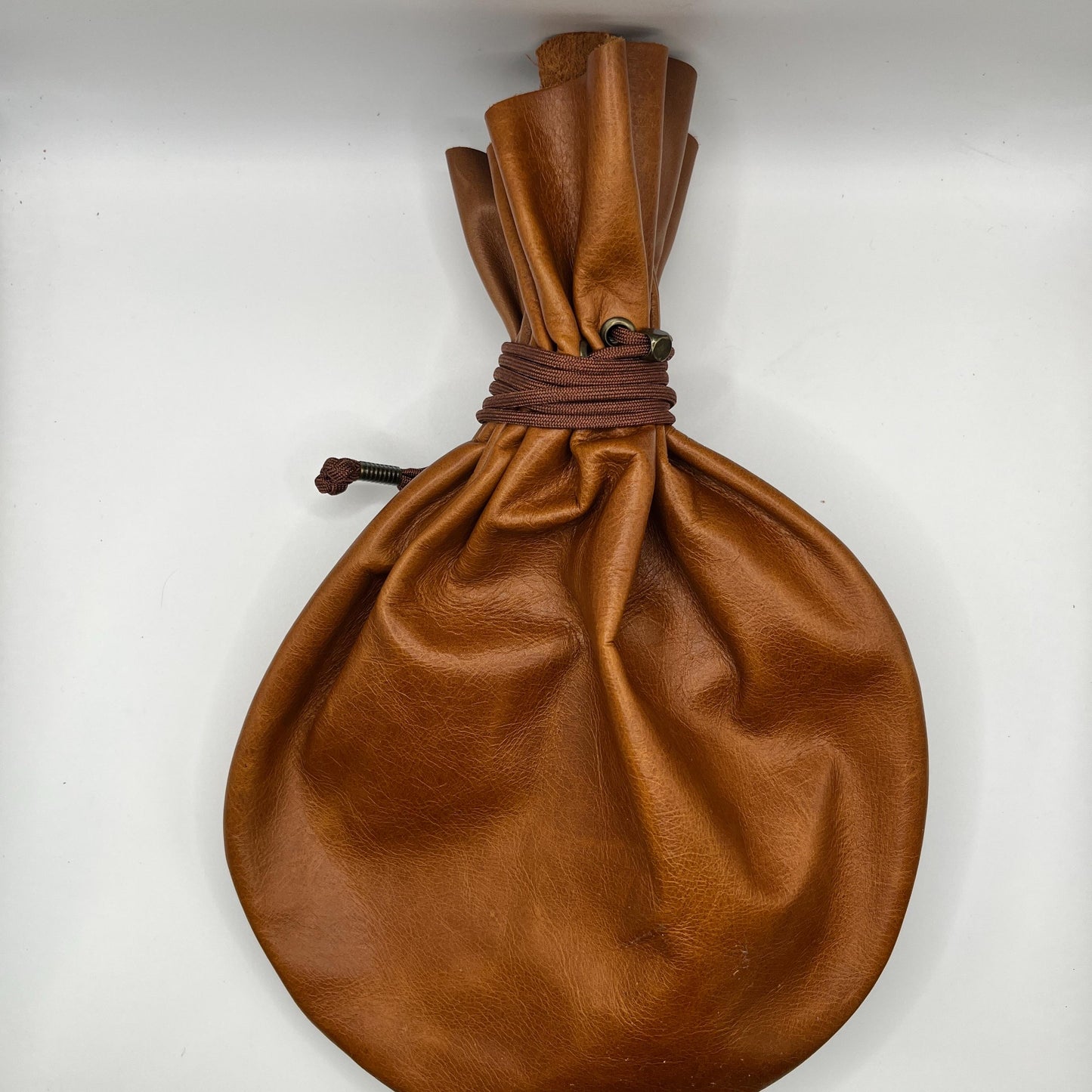 Handcrafted leather dice bag with drawstring, ideal for storing RPG dice sets. Perfect for DnD, tabletop games, or as a fantasy gift for gamers.