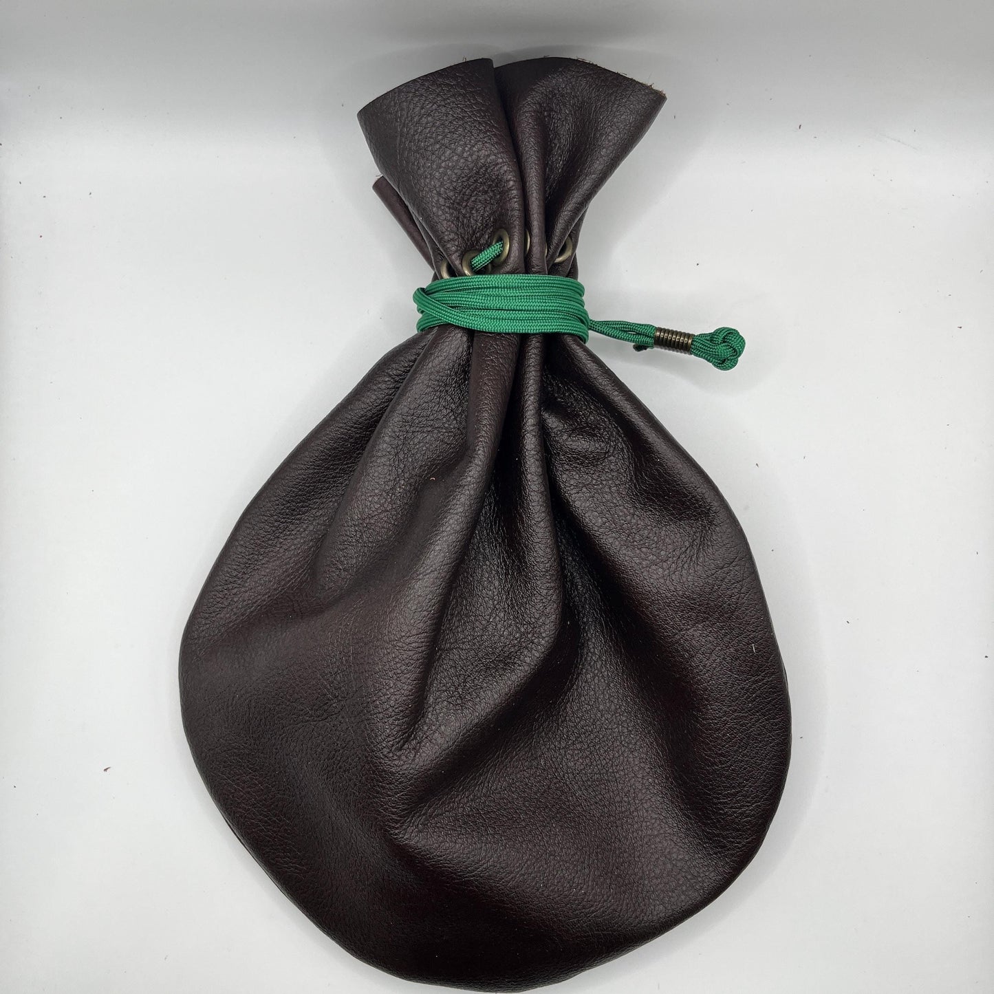 Handcrafted leather dice bag with drawstring, ideal for storing RPG dice sets. Perfect for DnD, tabletop games, or as a fantasy gift for gamers.