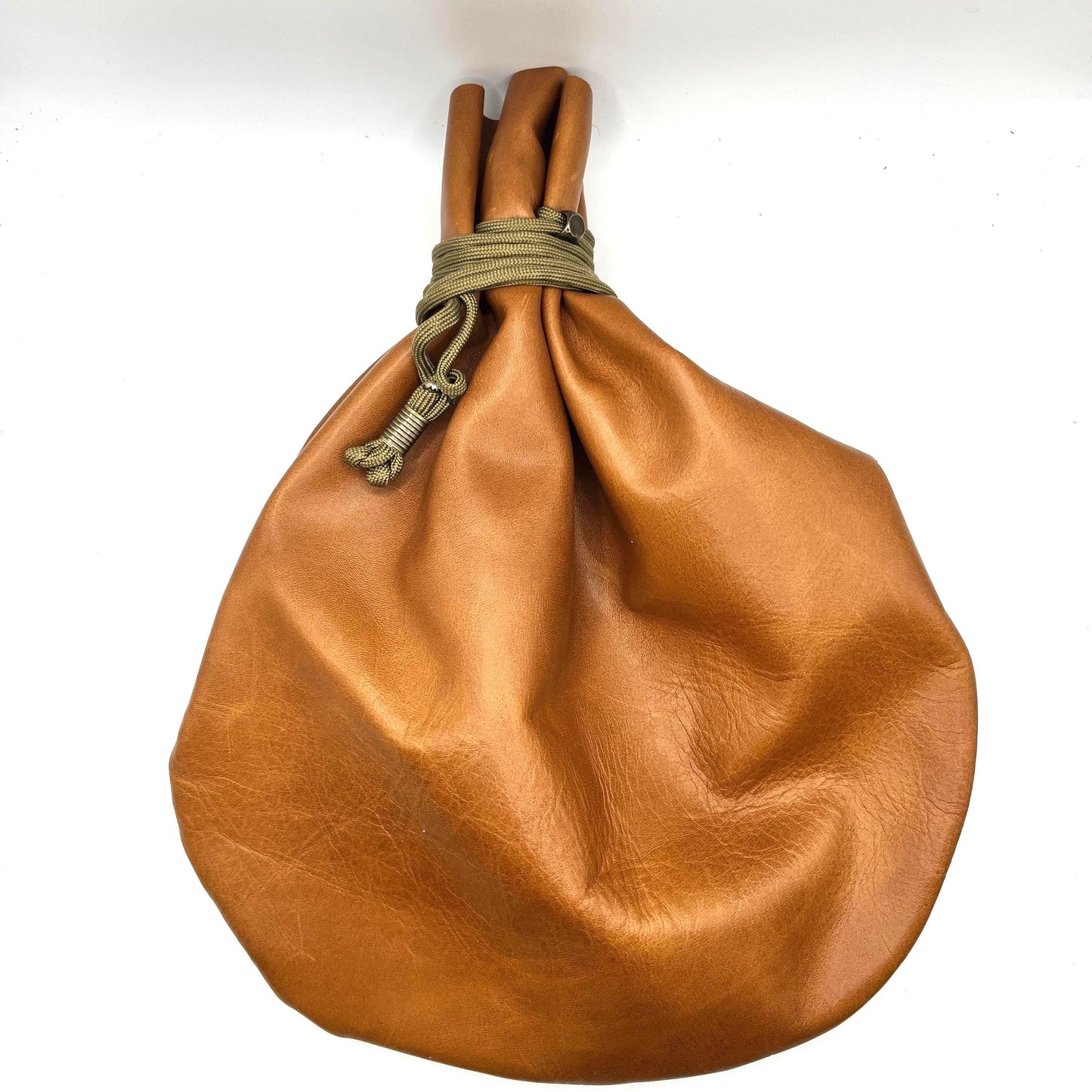 Handcrafted leather dice bag with drawstring, ideal for storing RPG dice sets. Perfect for DnD, tabletop games, or as a fantasy gift for gamers.