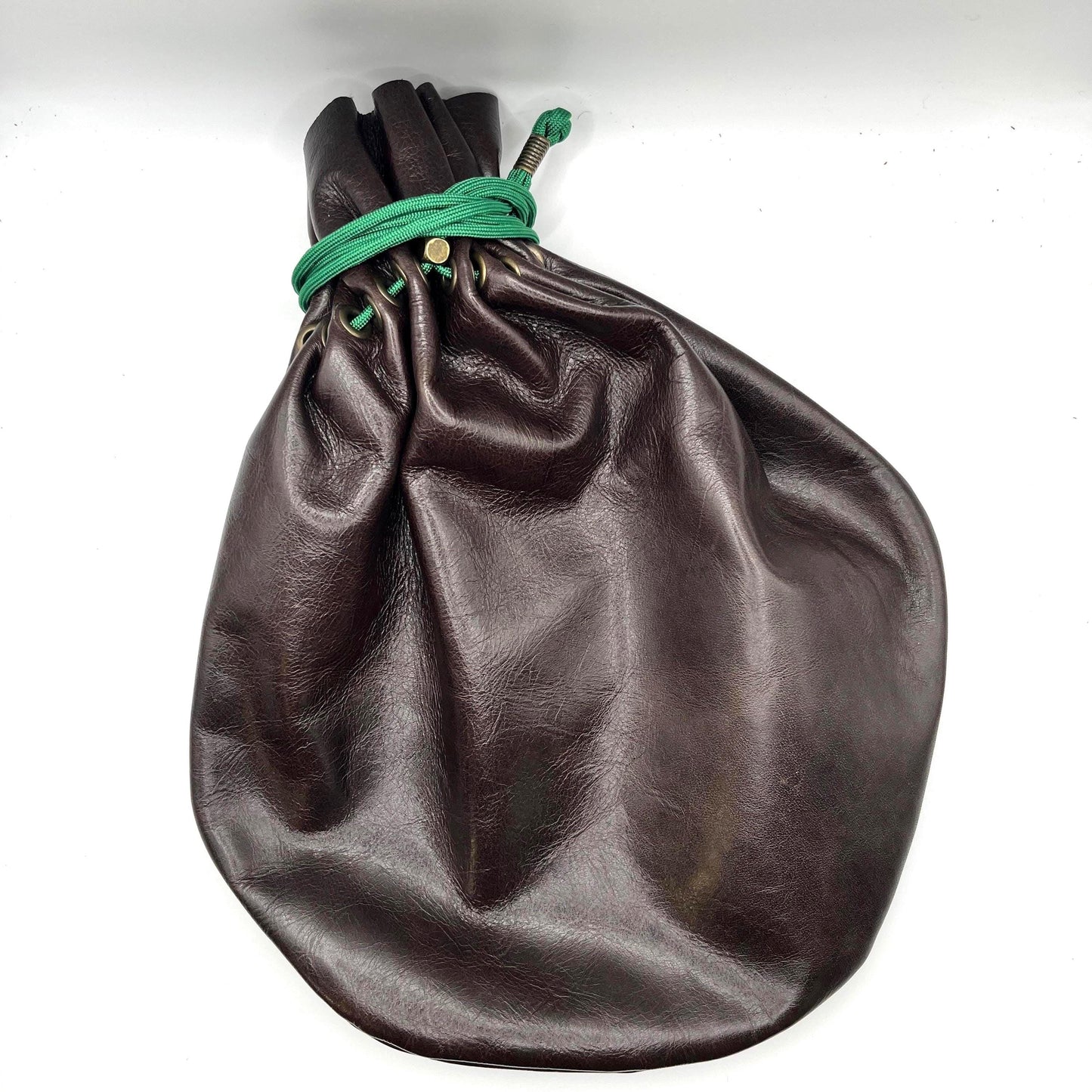 Handcrafted leather dice bag with drawstring, ideal for storing RPG dice sets. Perfect for DnD, tabletop games, or as a fantasy gift for gamers.
