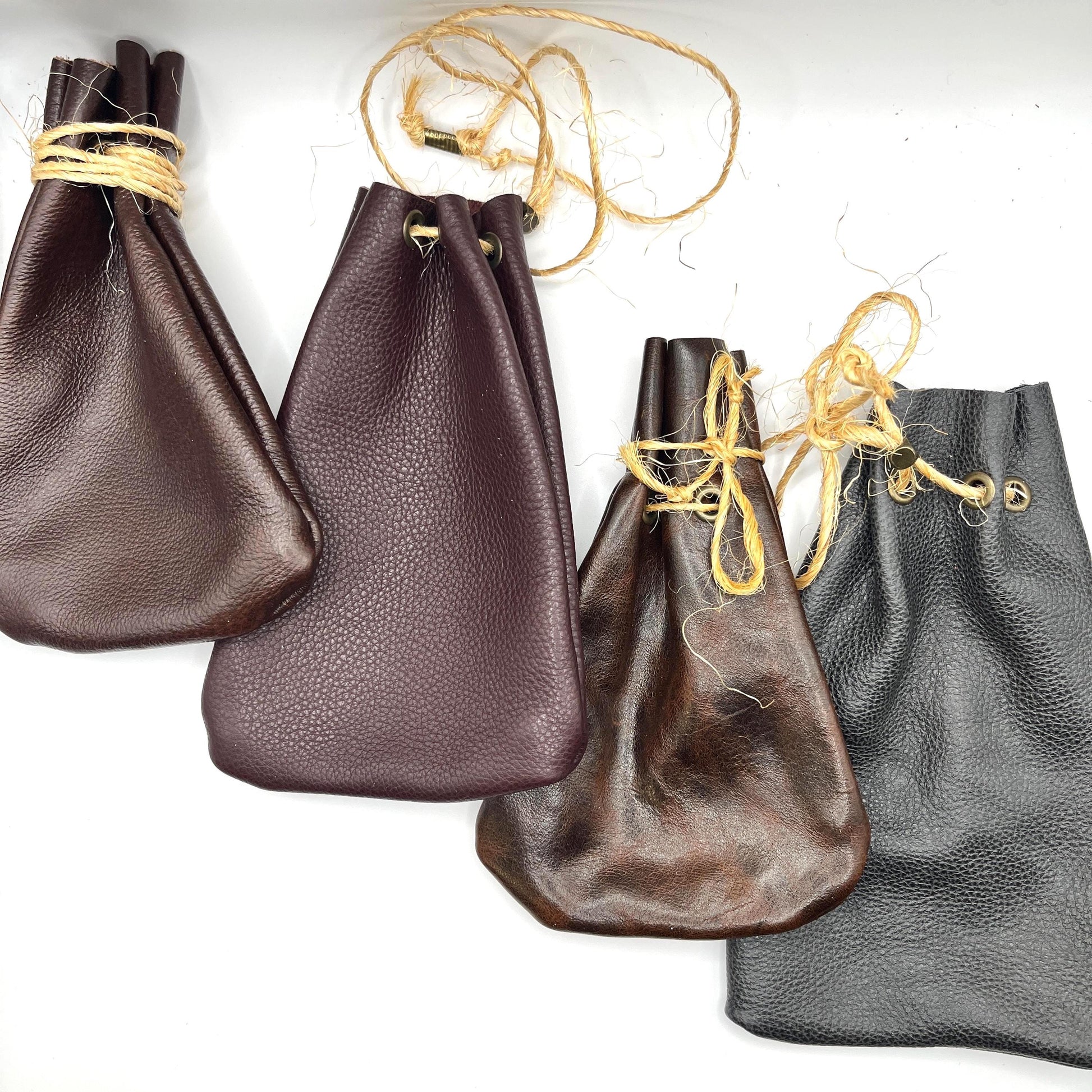 Handcrafted leather dice bag with drawstring, ideal for storing RPG dice sets. Perfect for DnD, tabletop games, or as a fantasy gift for gamers.