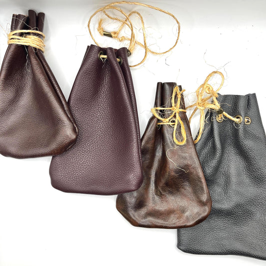 Handcrafted leather dice bag with drawstring, ideal for storing RPG dice sets. Perfect for DnD, tabletop games, or as a fantasy gift for gamers.