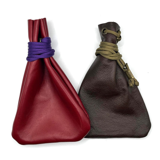 Handcrafted leather dice bag with drawstring, ideal for storing RPG dice sets. Perfect for DnD, tabletop games, or as a fantasy gift for gamers.