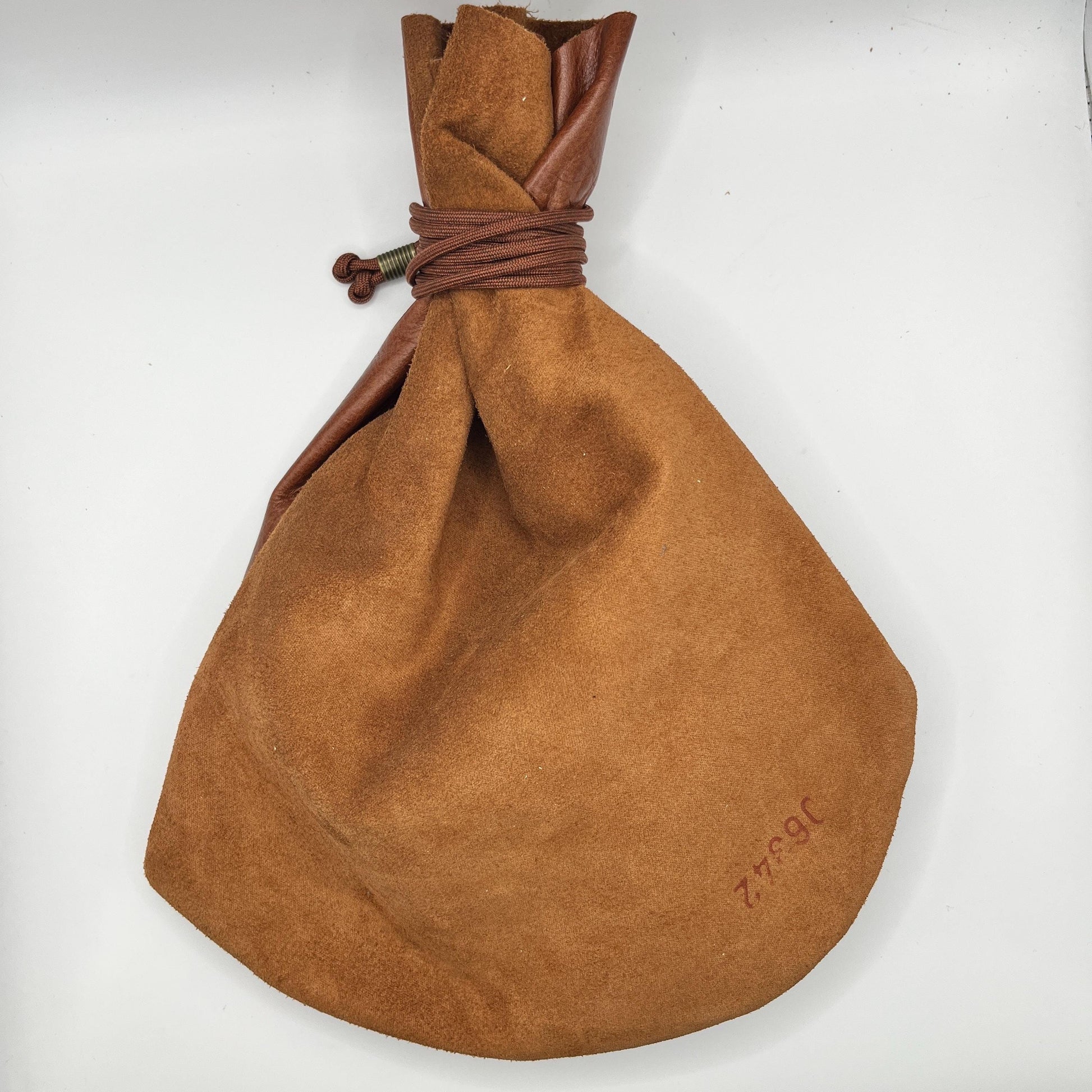 Handcrafted leather dice bag with drawstring, ideal for storing RPG dice sets. Perfect for DnD, tabletop games, or as a fantasy gift for gamers.