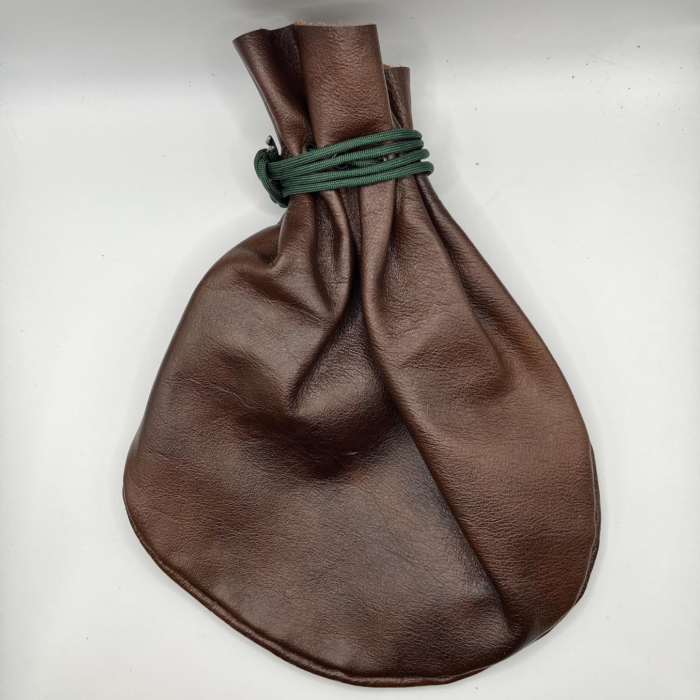 Handcrafted leather dice bag with drawstring, ideal for storing RPG dice sets. Perfect for DnD, tabletop games, or as a fantasy gift for gamers.