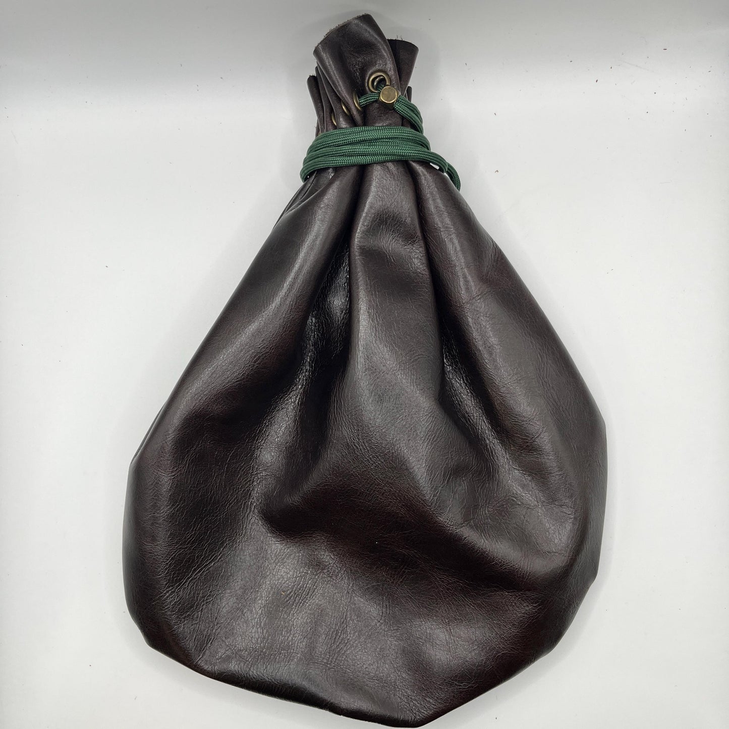 Handcrafted leather dice bag with drawstring, ideal for storing RPG dice sets. Perfect for DnD, tabletop games, or as a fantasy gift for gamers.