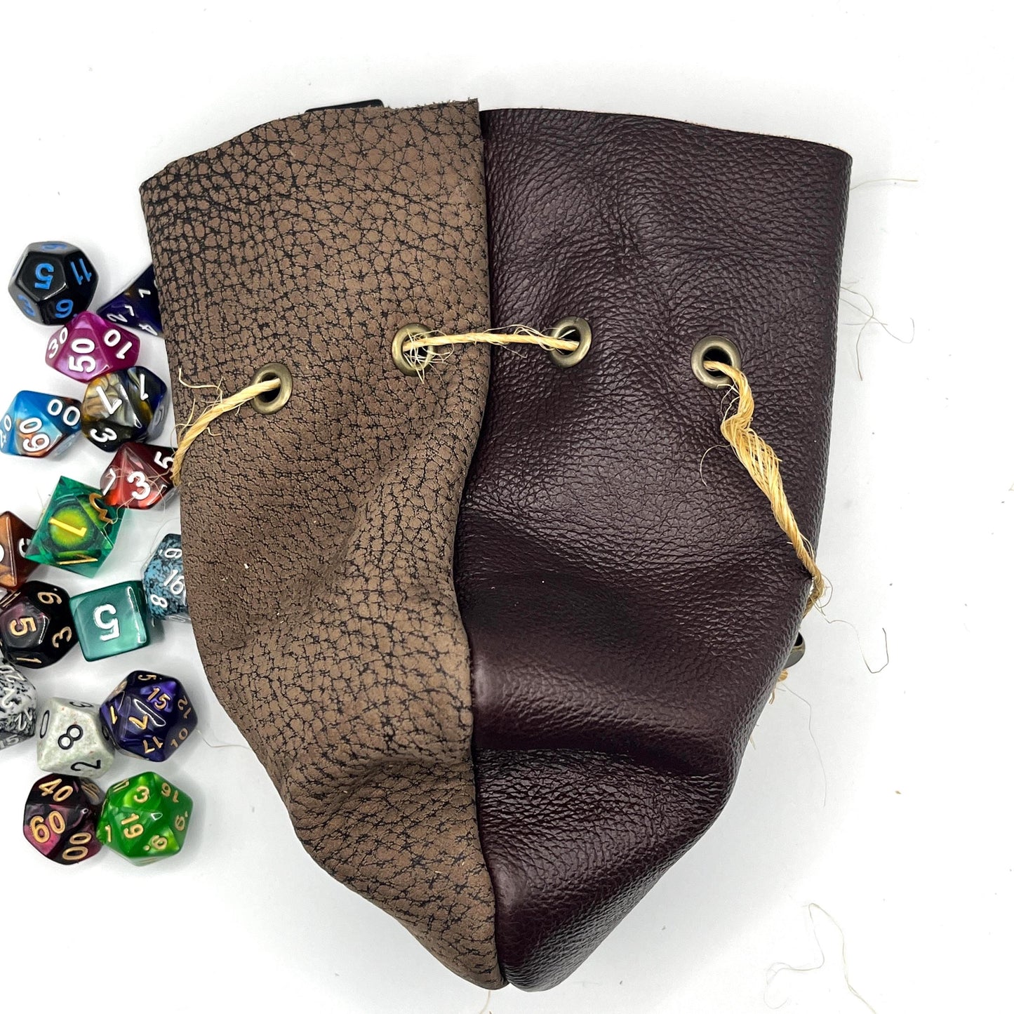 Handcrafted leather dice bag with drawstring, ideal for storing RPG dice sets. Perfect for DnD, tabletop games, or as a fantasy gift for gamers.