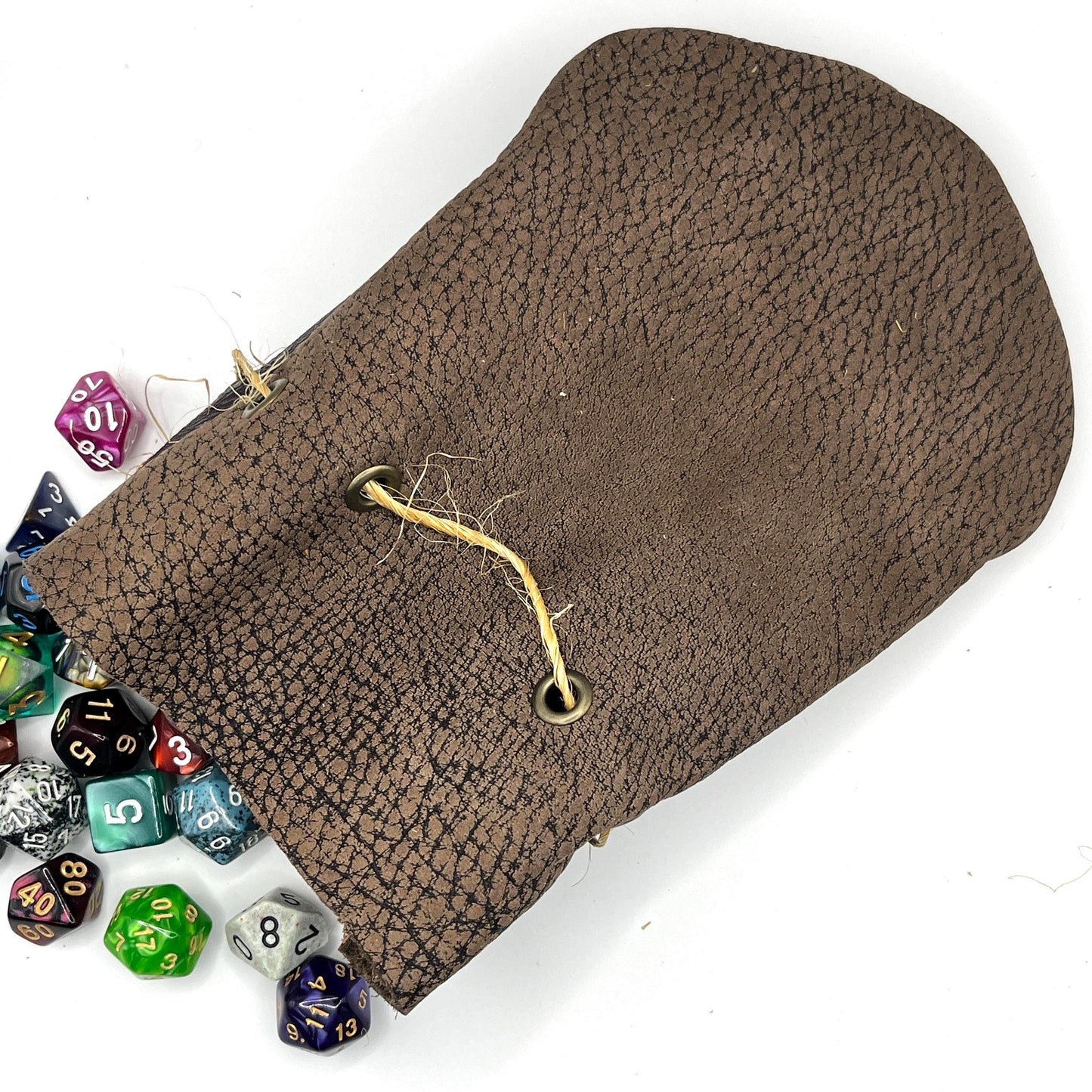 Handcrafted leather dice bag with drawstring, ideal for storing RPG dice sets. Perfect for DnD, tabletop games, or as a fantasy gift for gamers.
