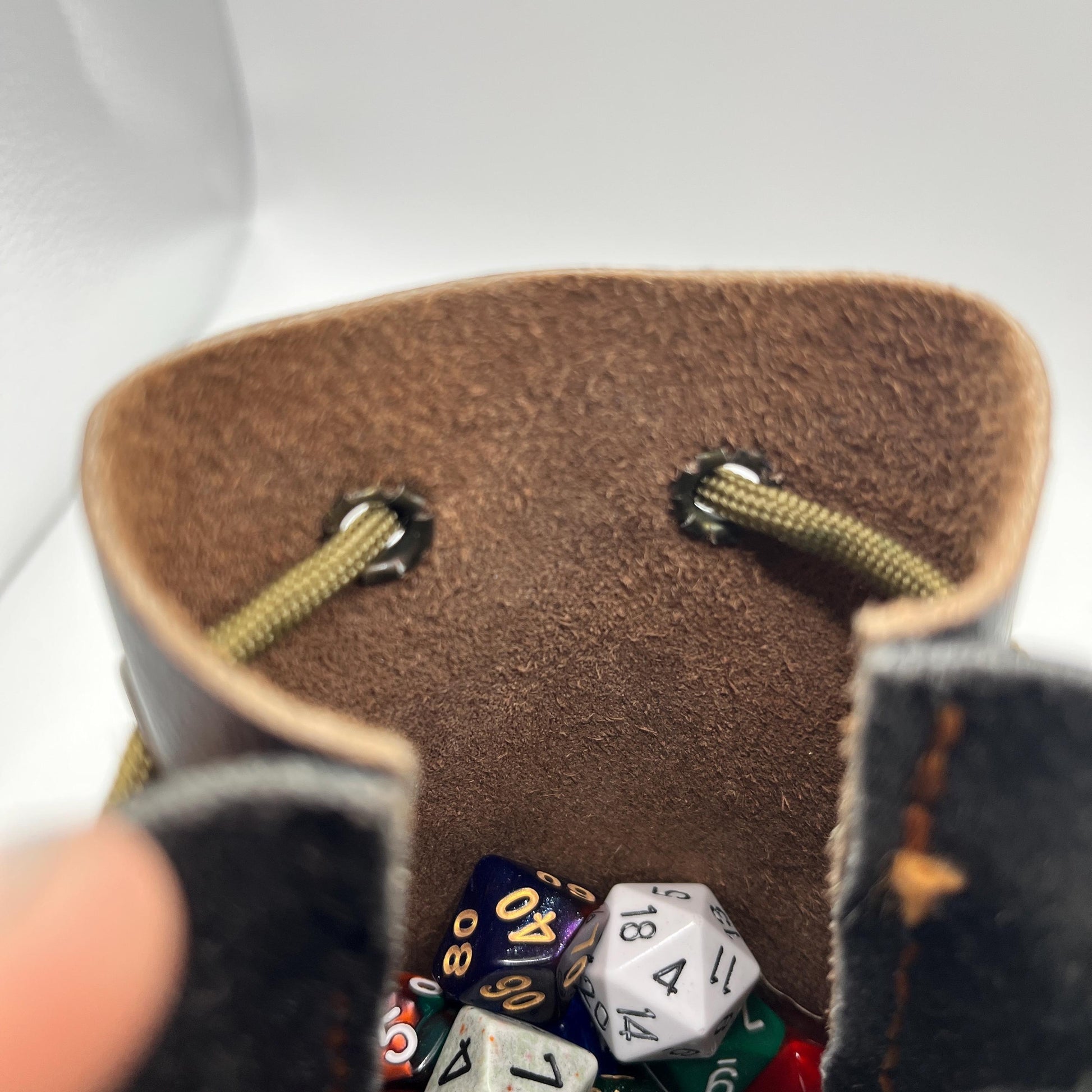 Handcrafted leather dice bag with drawstring, ideal for storing RPG dice sets. Perfect for DnD, tabletop games, or as a fantasy gift for gamers.