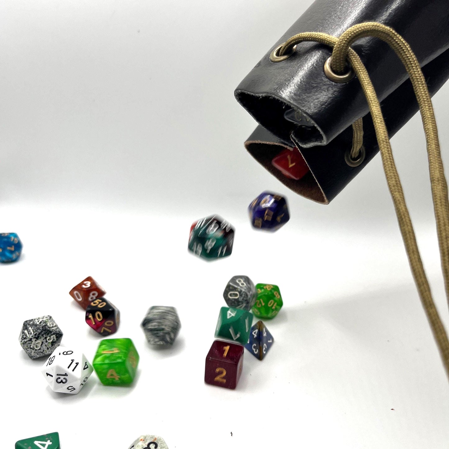 Handcrafted leather dice bag with drawstring, ideal for storing RPG dice sets. Perfect for DnD, tabletop games, or as a fantasy gift for gamers.