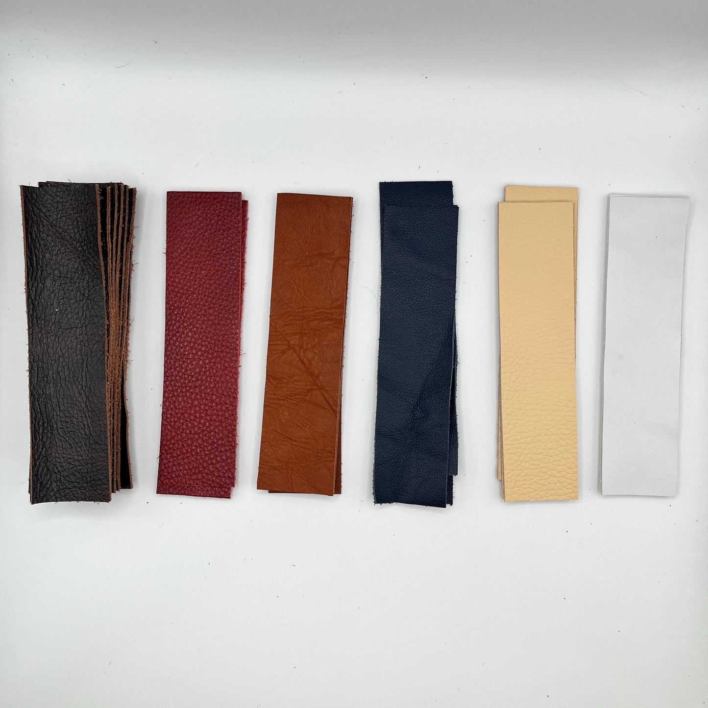 Handmade upcycled Italian leather bookmark cut from upholstery-grade leather scraps, slim durable page marker with natural grain, sustainable gift for readers and book lovers