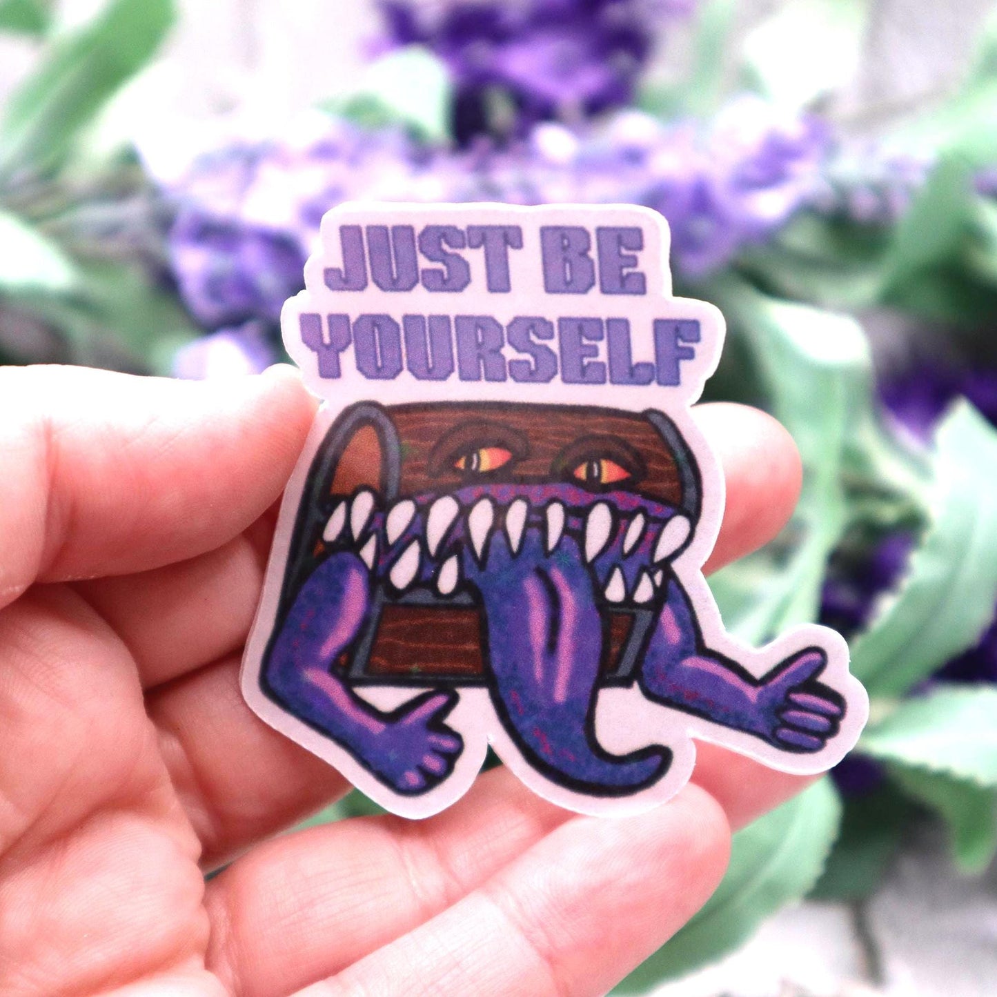 Holographic DnD mimic sticker with a grinning treasure chest and the phrase Just Be Yourself, perfect for laptops, water bottles, and tabletop RPG fans.