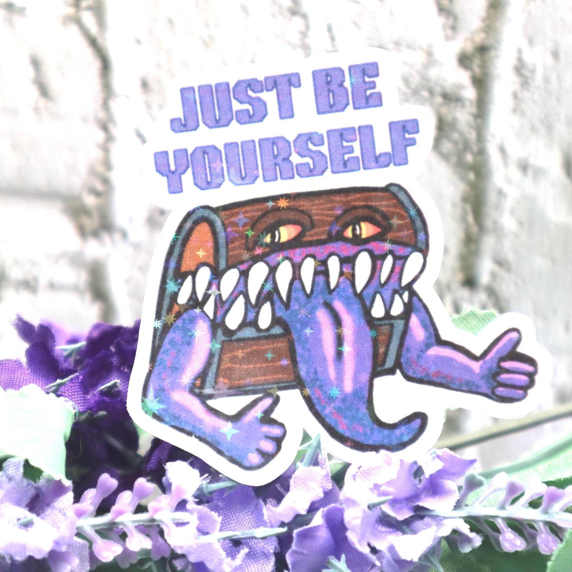 Holographic DnD mimic sticker with a grinning treasure chest and the phrase Just Be Yourself, perfect for laptops, water bottles, and tabletop RPG fans.