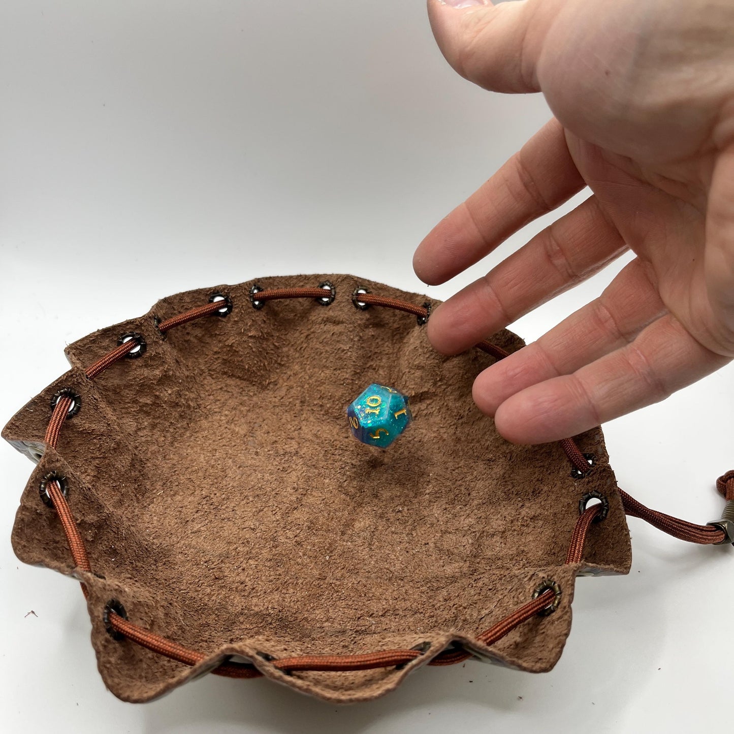 Handcrafted leather dice bag with drawstring, ideal for storing RPG dice sets. Perfect for DnD, tabletop games, or as a fantasy gift for gamers.