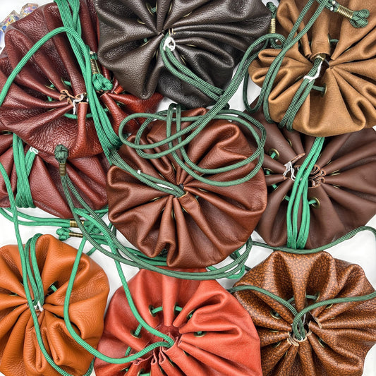 Handcrafted leather dice bag with drawstring, ideal for storing RPG dice sets. Perfect for DnD, tabletop games, or as a fantasy gift for gamers.