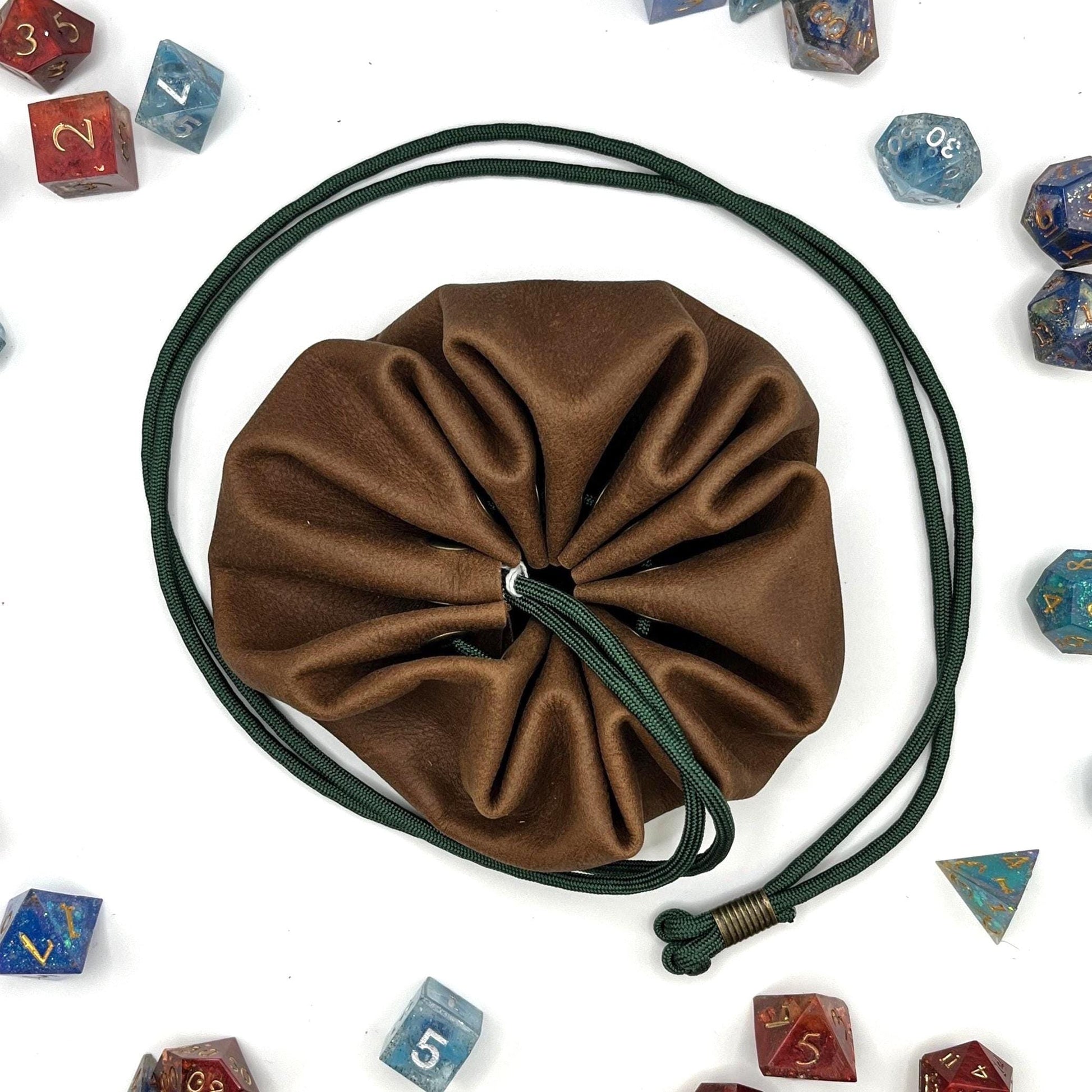Handcrafted leather dice bag with drawstring, ideal for storing RPG dice sets. Perfect for DnD, tabletop games, or as a fantasy gift for gamers.